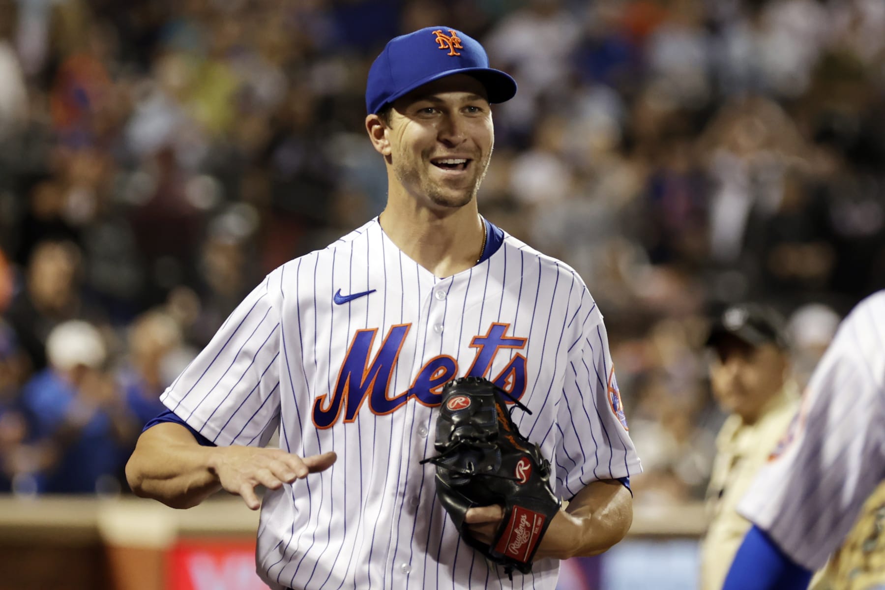 New York Mets pitcher Jacob deGrom reacts toward Brandon Nimmo after the seventh inning of the team's baseball game against the Los Angeles Dodgers on Wednesday, Aug. 31, 2022, in New York. The Mets won 2-1. (AP Photo/Adam Hunger)