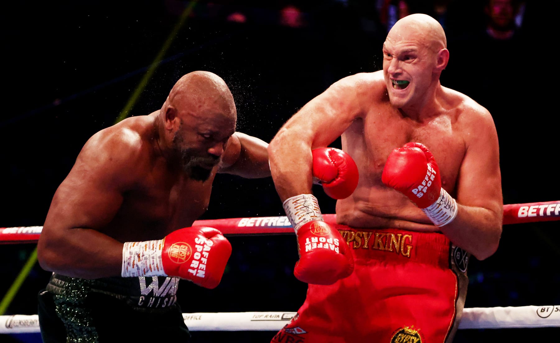 LONDON, ENGLAND - DECEMBER 03: Tyson Fury (R) punches  Derek Chisora (L) during the WBC World Heavyweight Title fight between Tyson Fury and Derek Chisora at Tottenham Hotspur Stadium on December 03, 2022 in London, England. (Photo by Warren Little/Getty Images)