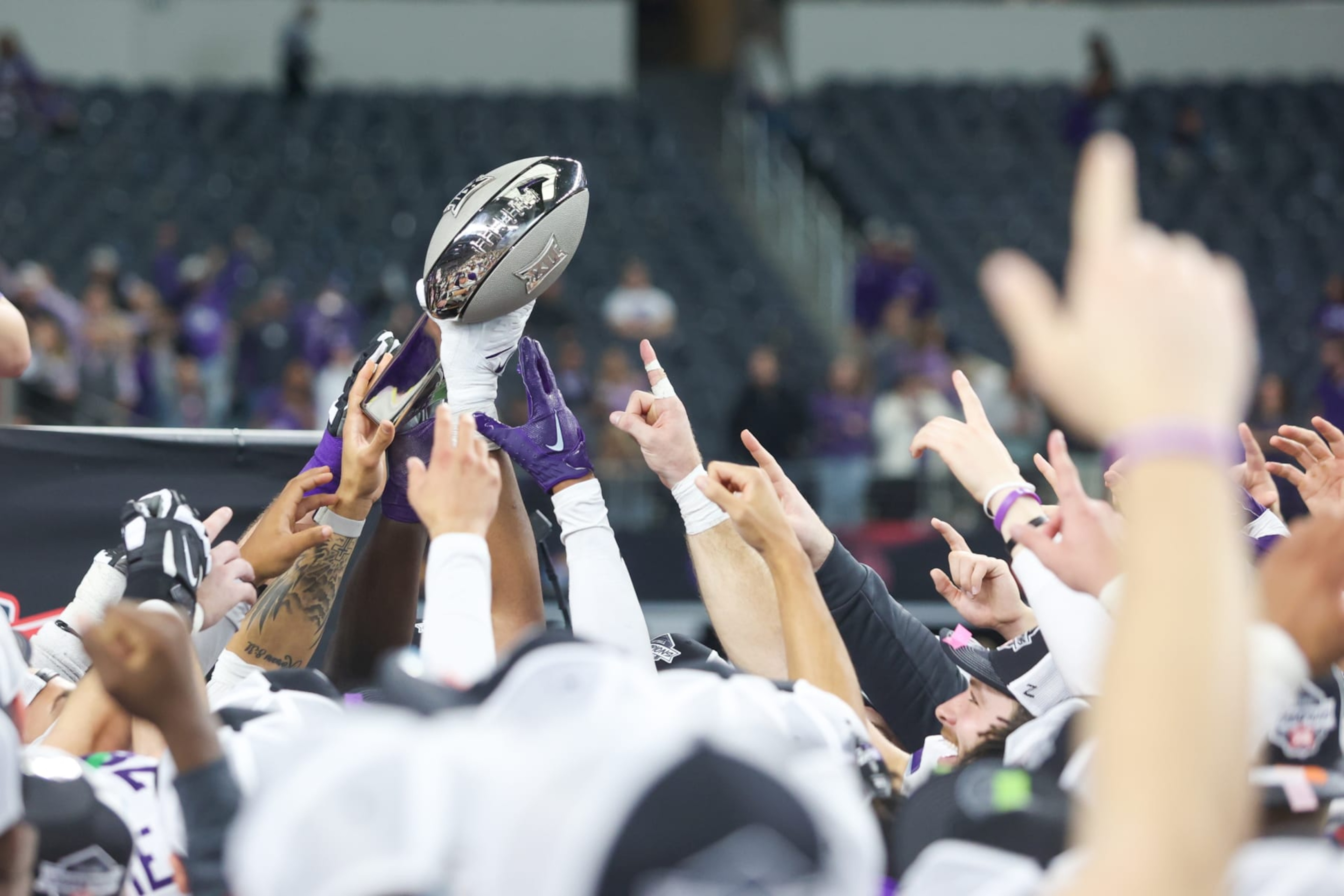 ARLINGTON, TX - DECEMBER 03: Kansas State Wildcats players celebrate with the trophy after winning the Big 12 Championship game between TCU and Kansas State on December 3, 2022 at AT&T Stadium in Arlington, TX. (Photo by George Walker/Icon Sportswire via Getty Images)
