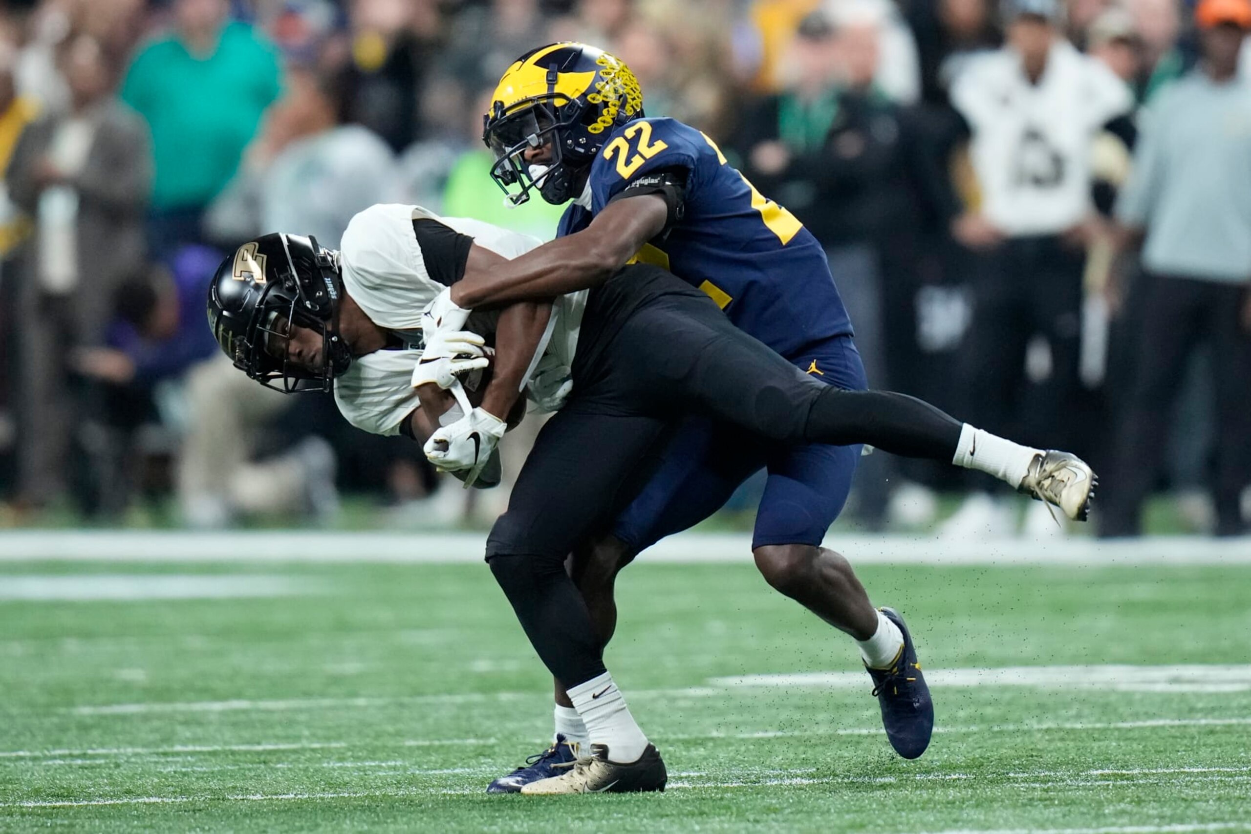 Purdue wide receiver TJ Sheffield runs with the ball as Michigan defensive back Gemon Green (22) defends during the first half of the Big Ten championship NCAA college football game, Saturday, Dec. 3, 2022, in Indianapolis. (AP Photo/AJ Mast)