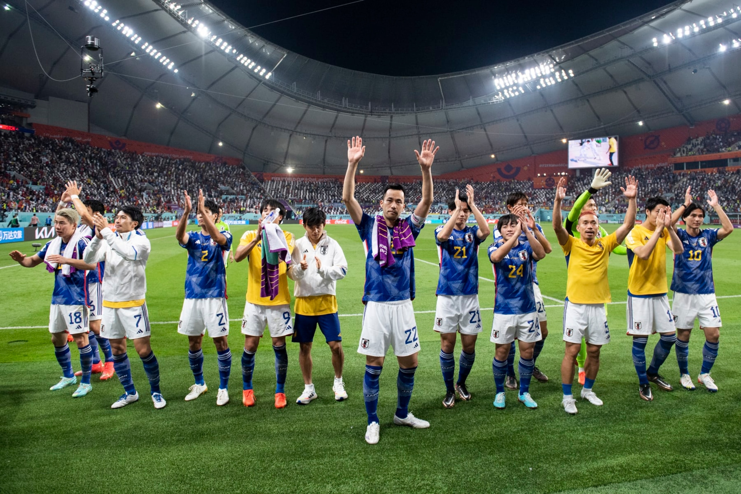 DOHA, QATAR - DECEMBER 01: Japan players celebrate winning the group as they applaud their fans at the end of the FIFA World Cup Qatar 2022 Group E match between Japan and Spain at Khalifa International Stadium on December 1, 2022 in Doha, Qatar. (Photo by Sebastian Frej/MB Media)