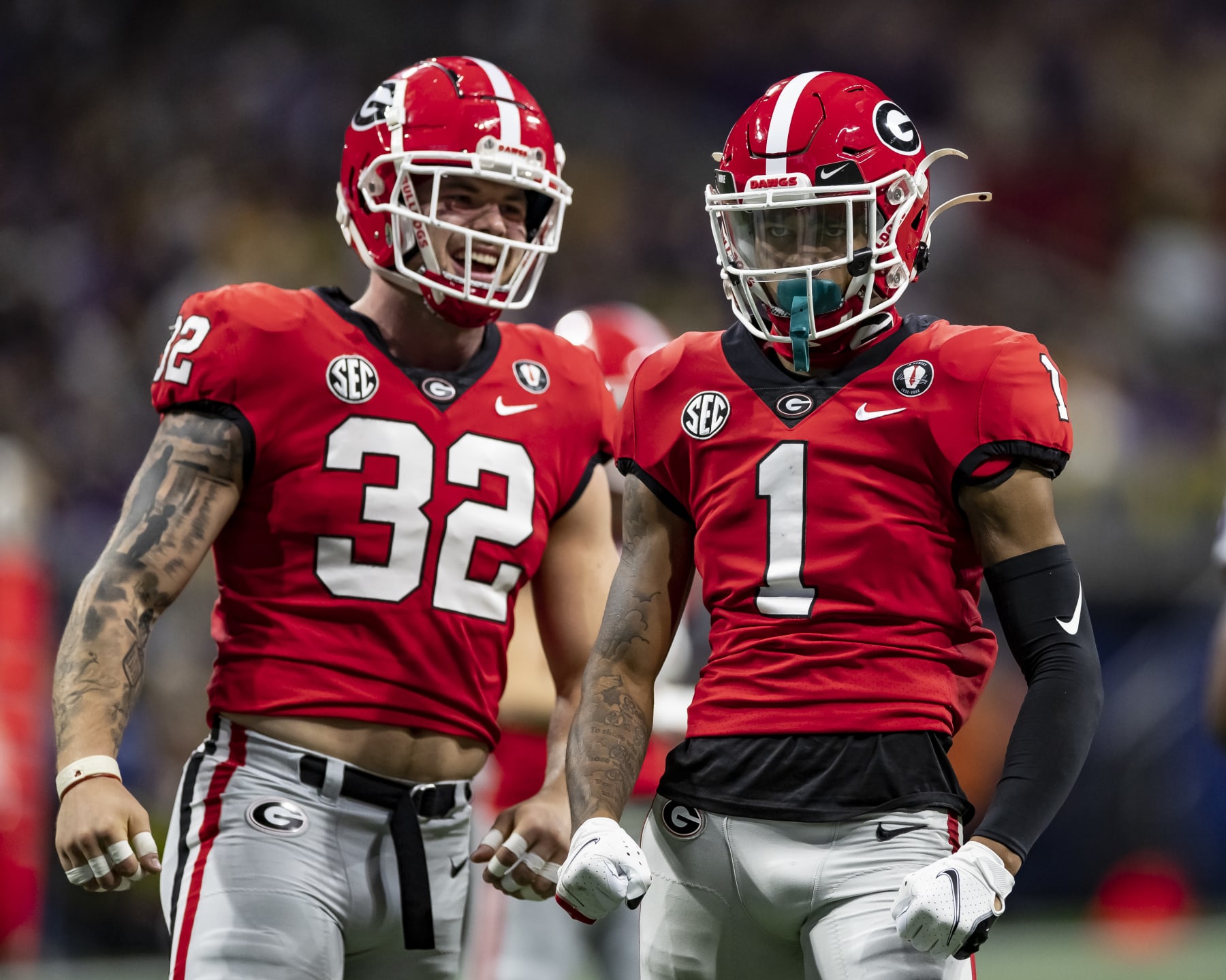 ATLANTA, GA - DECEMBER 3: Nyland Green #1 and Chaz Chambliss #32 of the Georgia Bulldogs celebrate a stop during a game between LSU Tigers and Georgia Bulldogs at Mercedes-Benz Stadium on December 3, 2022 in Atlanta, Georgia. (Photo by Steve Limentani/ISI Photos/Getty Images)
