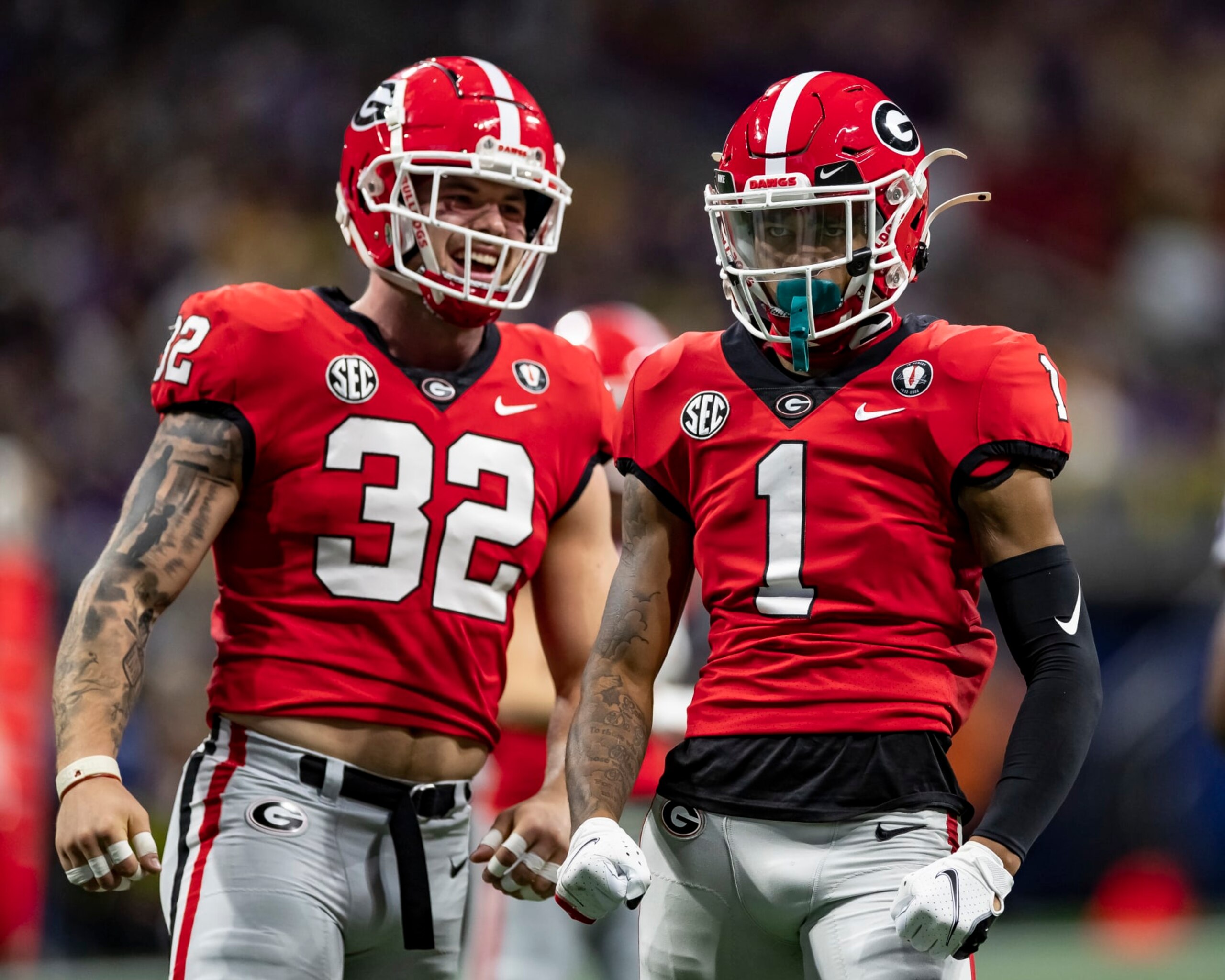 ATLANTA, GA - DECEMBER 3: Nyland Green #1 and Chaz Chambliss #32 of the Georgia Bulldogs celebrate a stop during a game between LSU Tigers and Georgia Bulldogs at Mercedes-Benz Stadium on December 3, 2022 in Atlanta, Georgia. (Photo by Steve Limentani/ISI Photos/Getty Images)