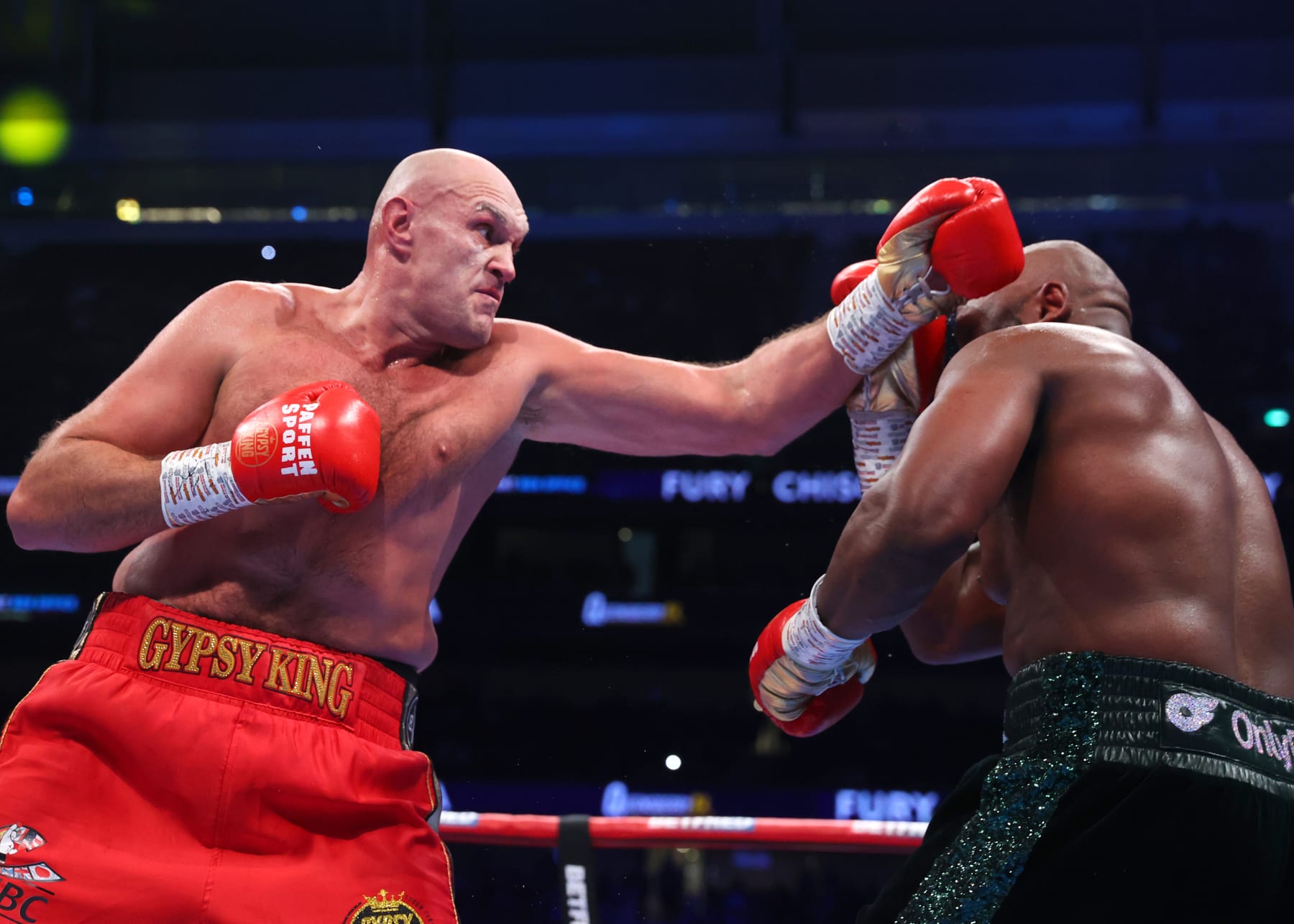 LONDON, ENGLAND - DECEMBER 03: Tyson Fury (L) and Derek Chisora (R) exchange punches during their WBC heavyweight championship fight, at Tottenham Hotspur Stadium on December 03, 2022 in London, England. (Photo by Mikey Williams/Top Rank Inc via Getty Images)