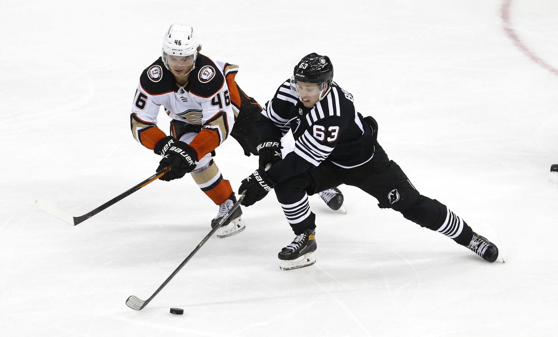 Anaheim Ducks center Trevor Zegras (left) and New Jersey Devils winger Jesper Bratt.