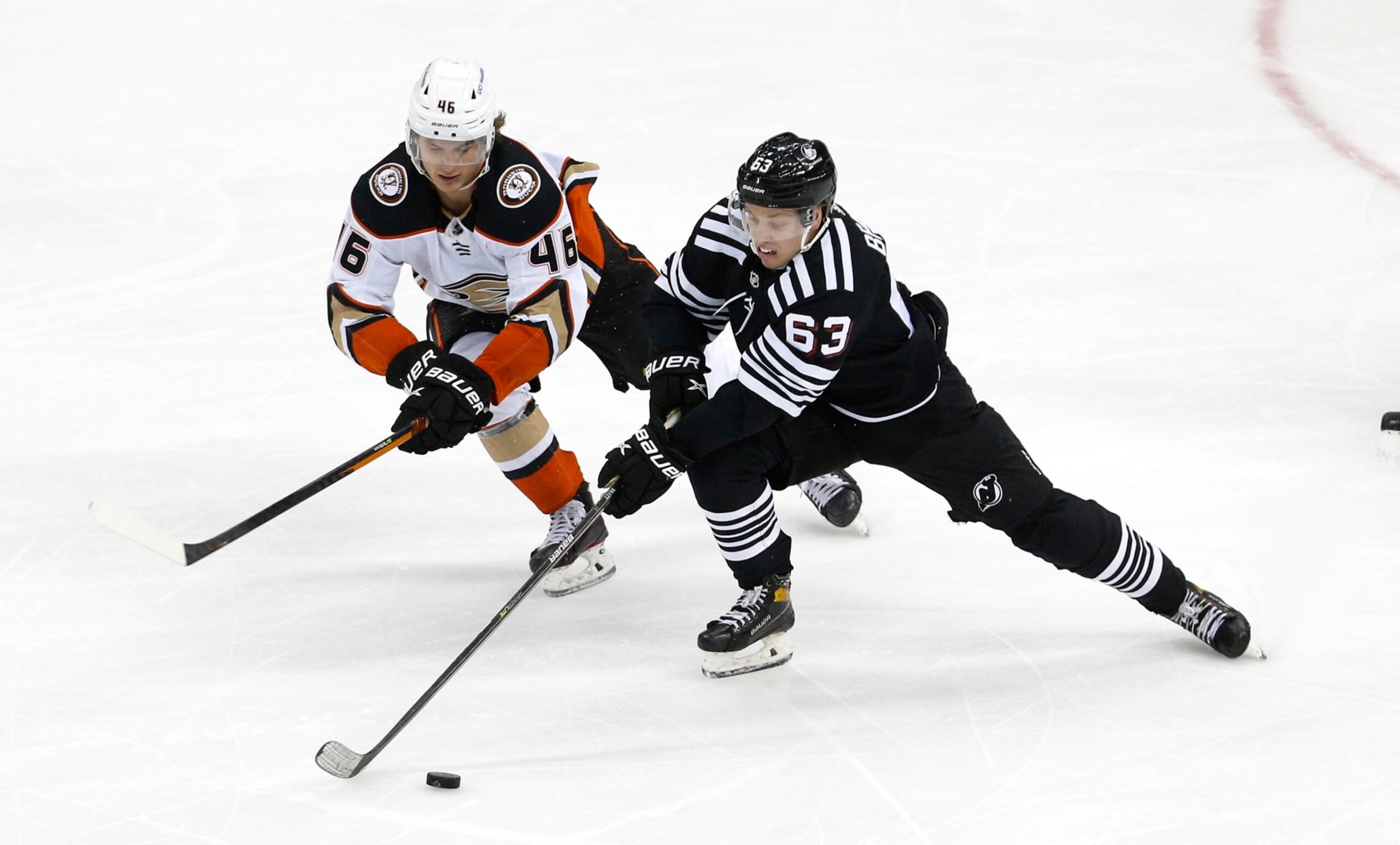 Anaheim Ducks center Trevor Zegras (left) and New Jersey Devils winger Jesper Bratt.