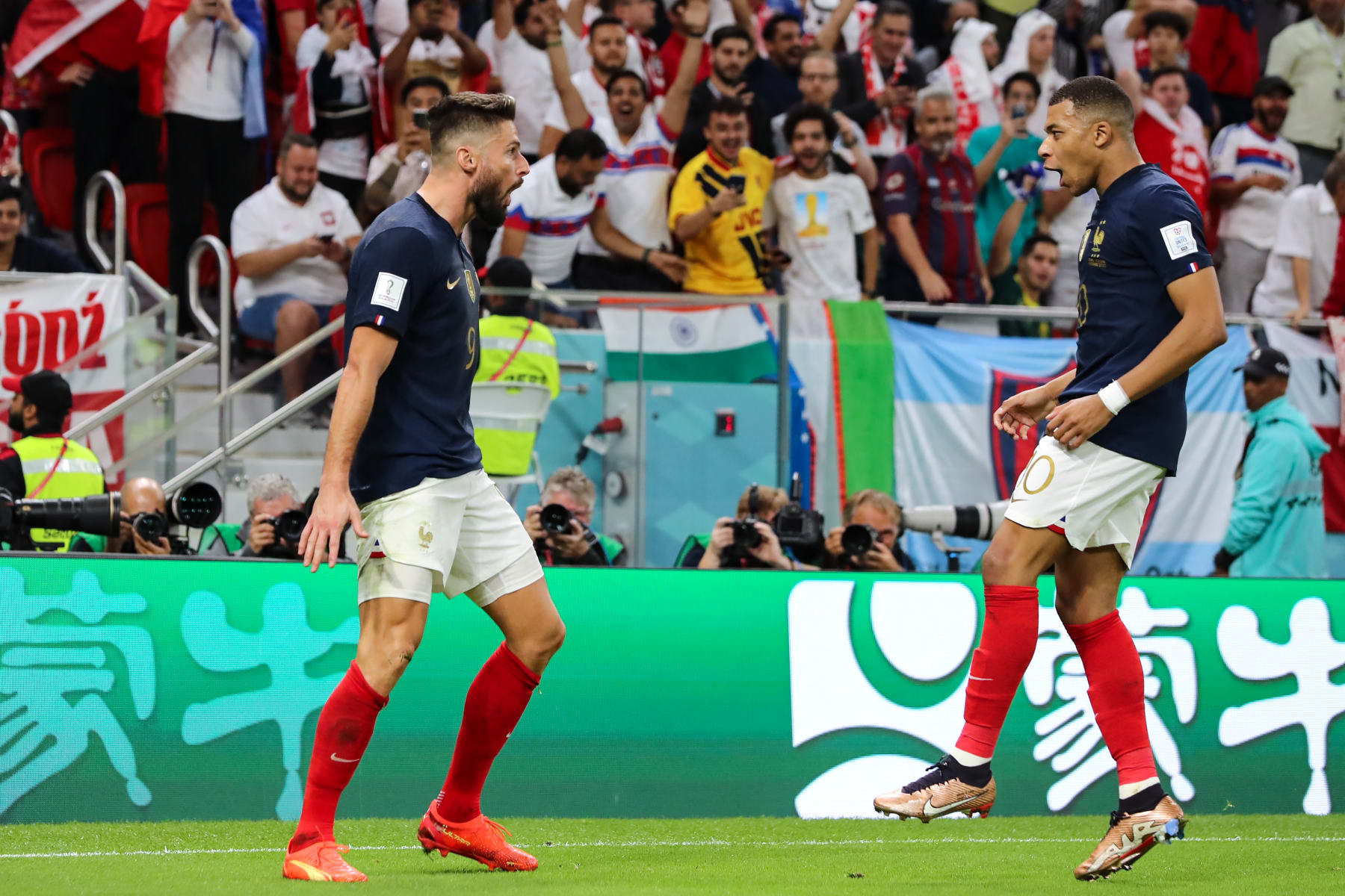 DOHA, QATAR - DECEMBER 04: Olivier Giroud of France celebrates with team mate Kylian Mbappe on becoming the all-time leading goalscorer for the France National team after scoring to give the side a 1-0 lead during the FIFA World Cup Qatar 2022 Round of 16 match between France and Poland at Al Thumama Stadium on December 04, 2022 in Doha, Qatar. (Photo by Youssef Loulidi/Fantasista/Getty Images)