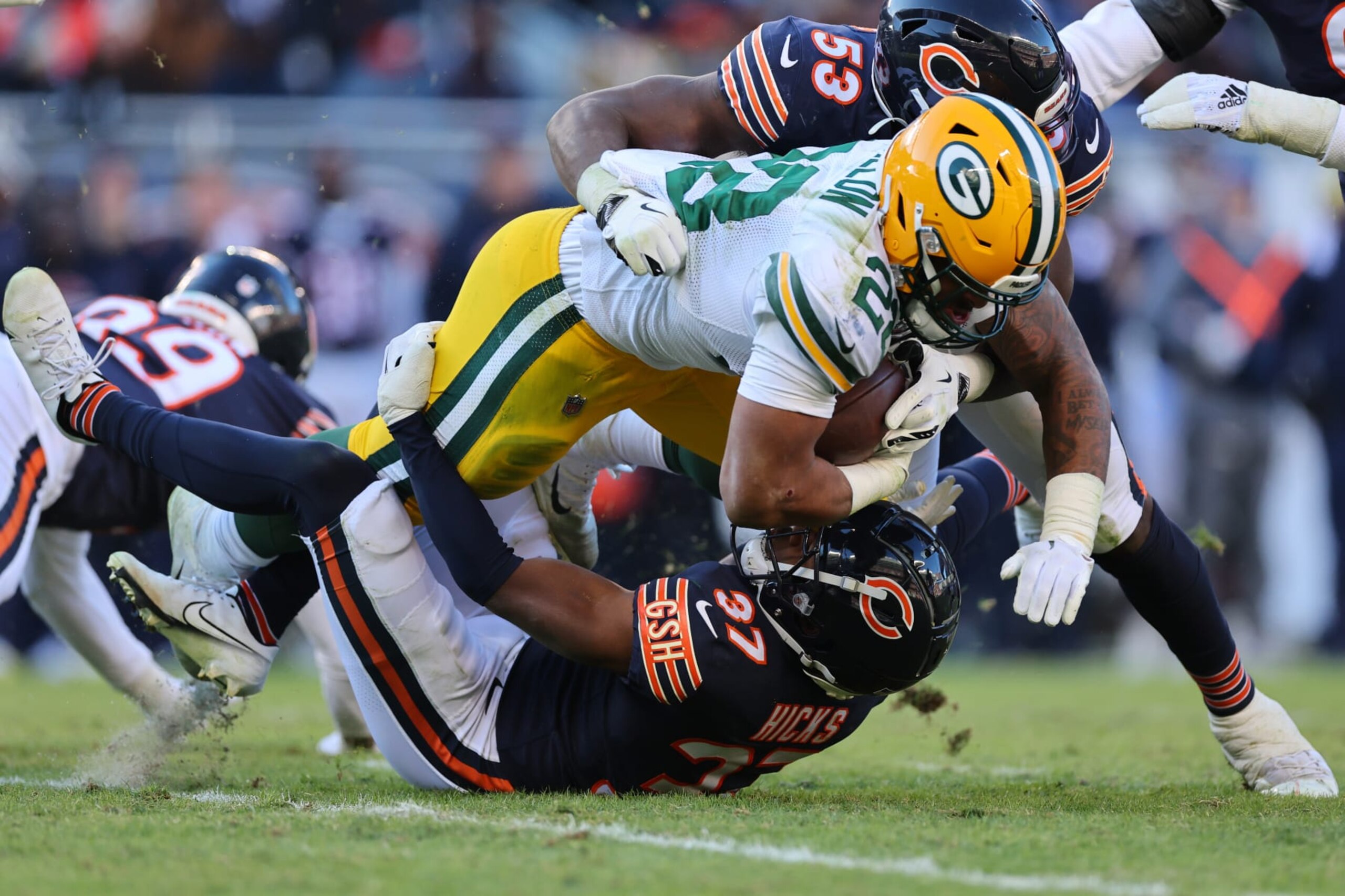 Packers RB AJ Dillon is tackled by Nicholas Morrow and Elijah Hicks.