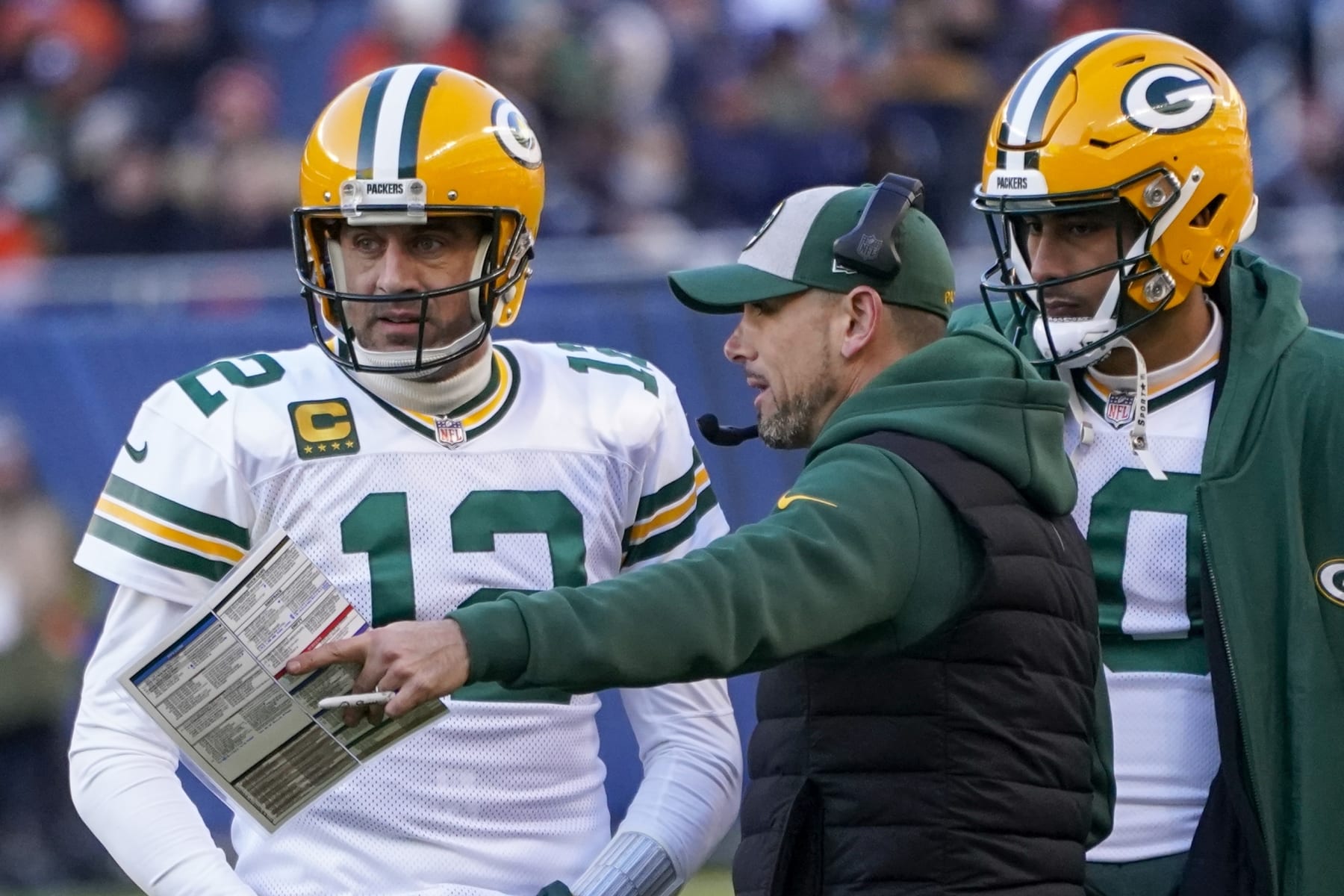 Green Bay Packers head coach Matt LaFleur talks to Aaron Rodgers during the second half of an NFL football game against the Chicago Bears Sunday, Dec. 4, 2022, in Chicago. (AP Photo/Charles Rex Arbogast)