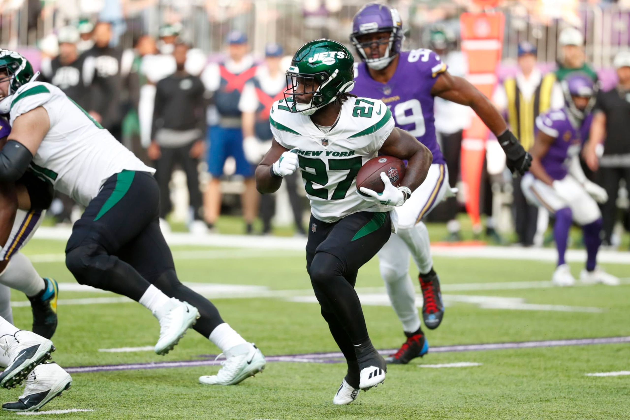 New York Jets running back Zonovan Knight (27) runs up field during the first half of an NFL football game against the Minnesota Vikings, Sunday, Dec. 4, 2022, in Minneapolis. (AP Photo/Bruce Kluckhohn)