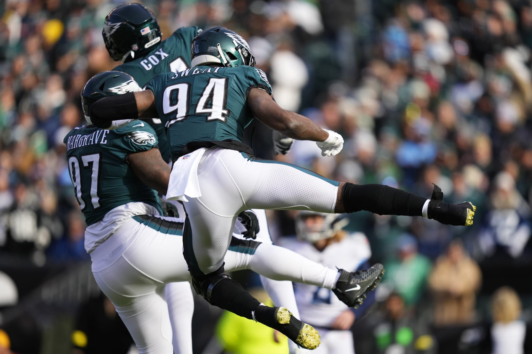 Philadelphia Eagles' Josh Sweat, right, Javon Hargrave, left, and Fletcher Cox celebrate a tackle by Hargrave during the first half of an NFL football game against the Tennessee Titans, Sunday, Dec. 4, 2022, in Philadelphia. (AP Photo/Matt Slocum)