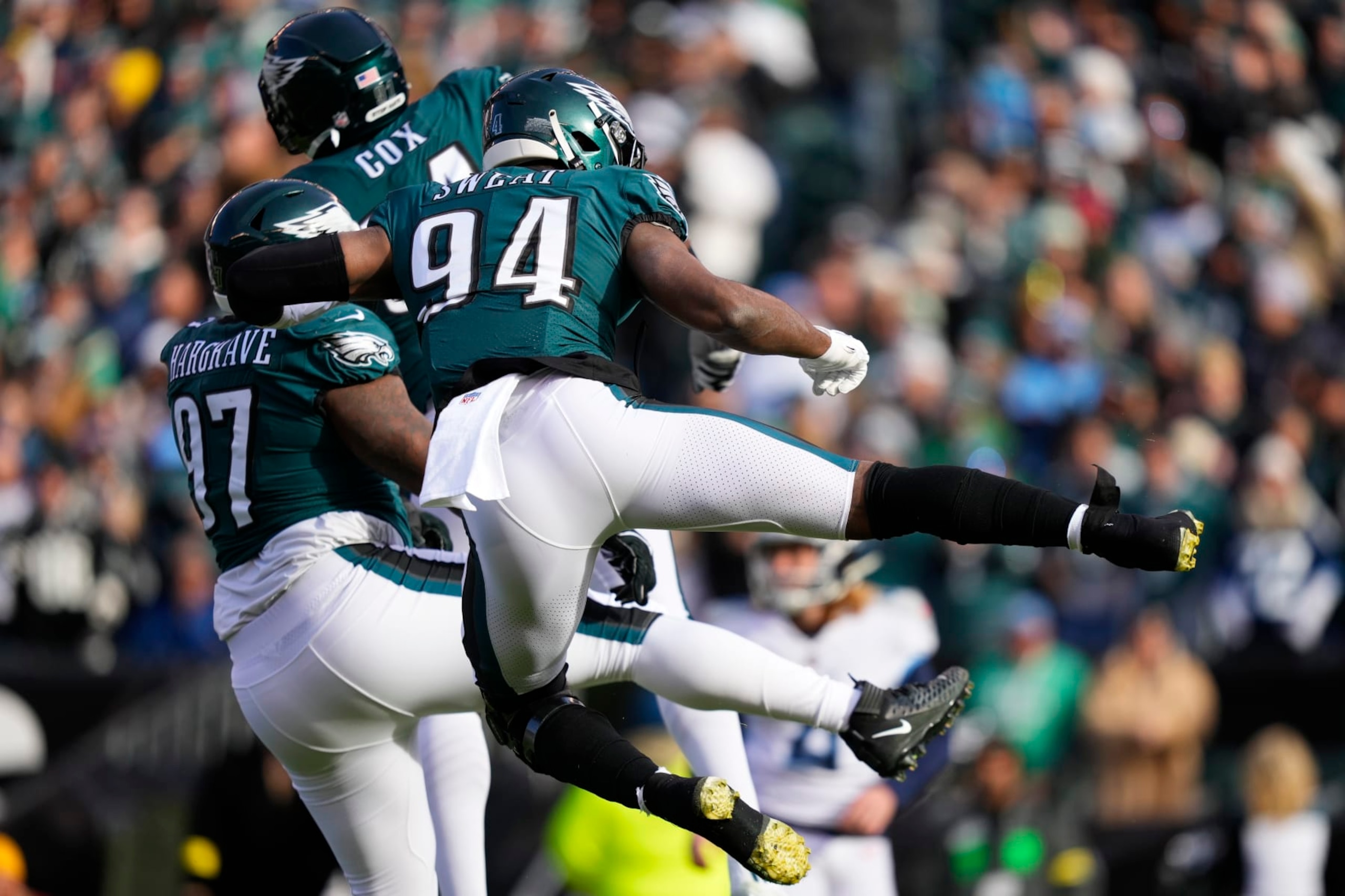 Philadelphia Eagles' Josh Sweat, right, Javon Hargrave, left, and Fletcher Cox celebrate a tackle by Hargrave during the first half of an NFL football game against the Tennessee Titans, Sunday, Dec. 4, 2022, in Philadelphia. (AP Photo/Matt Slocum)