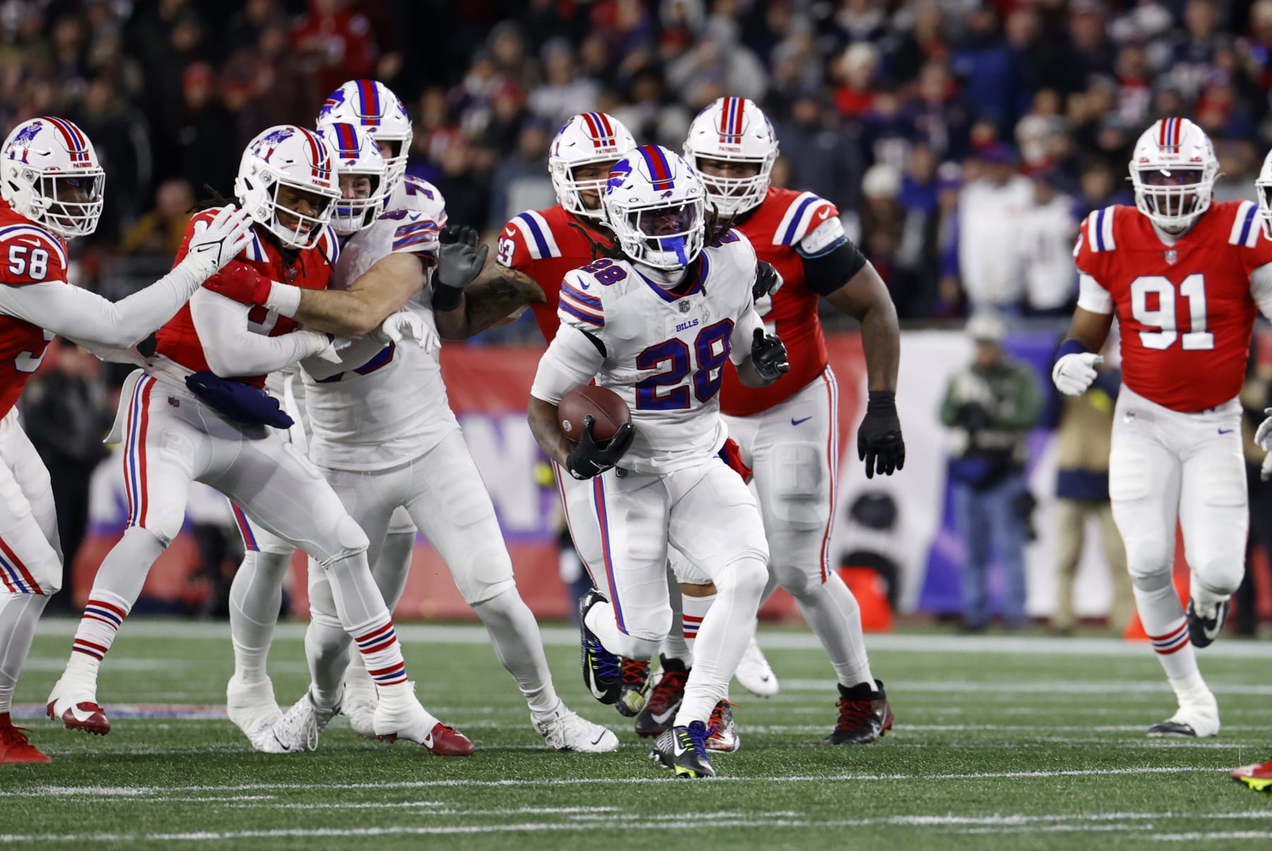FOXBOROUGH, MA - DECEMBER 01: Buffalo Bills running back James Cook (28) breaks through the line of scrimmage during a game between the New England Patriots and the Buffalo Bills on December 1, 2022, at Gillette Stadium in Foxborough, Massachusetts. (Photo by Fred Kfoury III/Icon Sportswire via Getty Images)