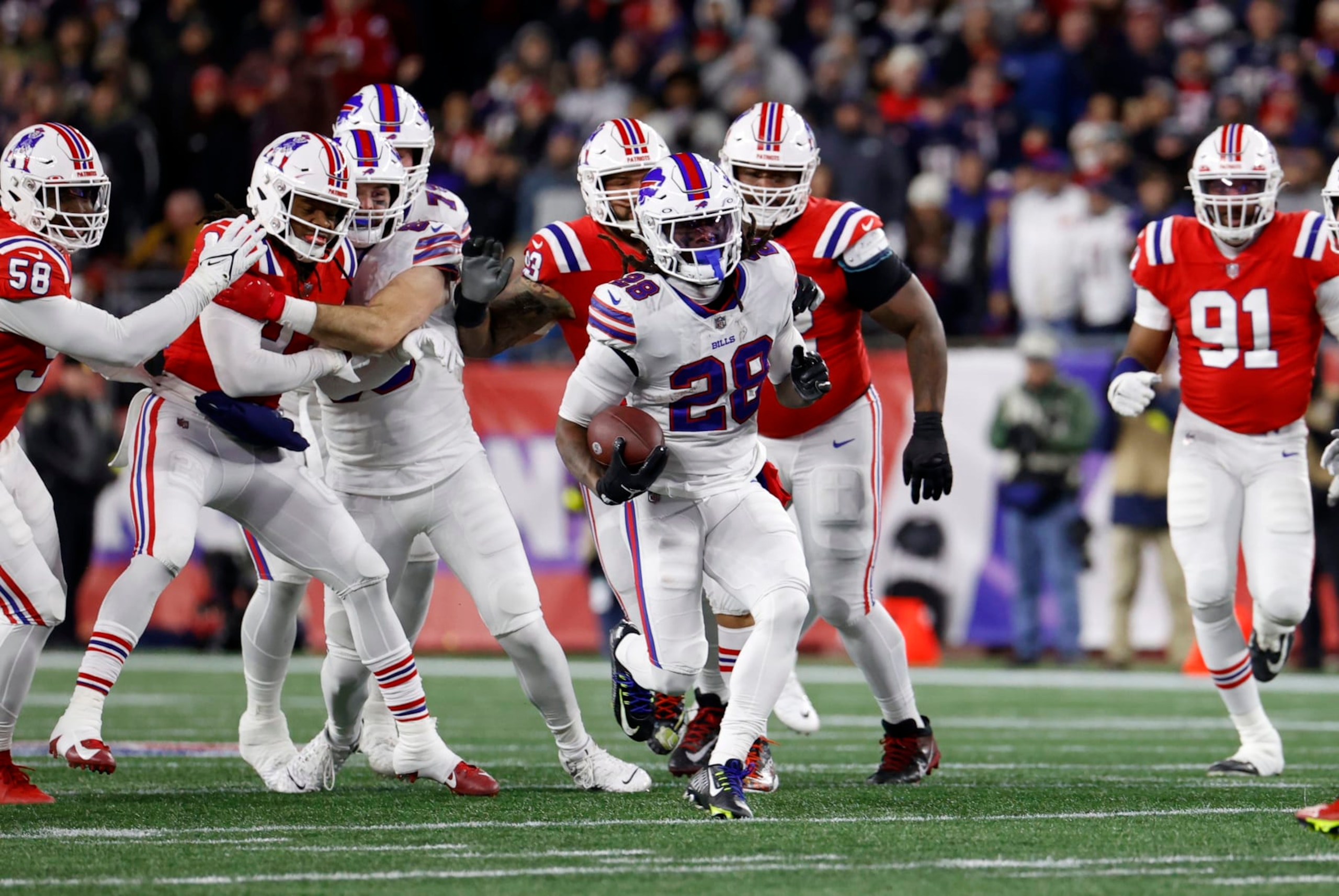 FOXBOROUGH, MA - DECEMBER 01: Buffalo Bills running back James Cook (28) breaks through the line of scrimmage during a game between the New England Patriots and the Buffalo Bills on December 1, 2022, at Gillette Stadium in Foxborough, Massachusetts. (Photo by Fred Kfoury III/Icon Sportswire via Getty Images)