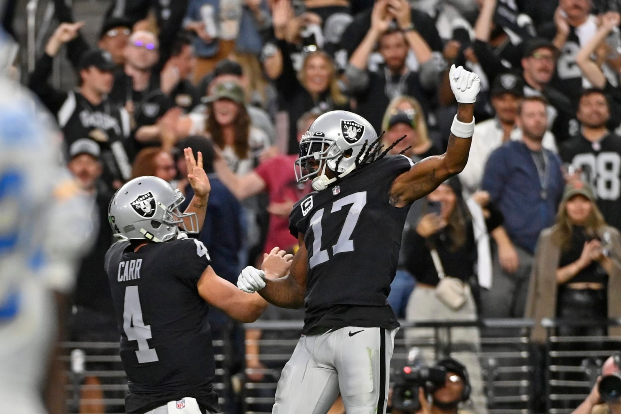 Las Vegas Raiders wide receiver Davante Adams (17) celebrates his touchdown reception with quarterback Derek Carr (4) during the second half of an NFL football game, Sunday, Dec. 4, 2022, in Las Vegas. (AP Photo/David Becker)