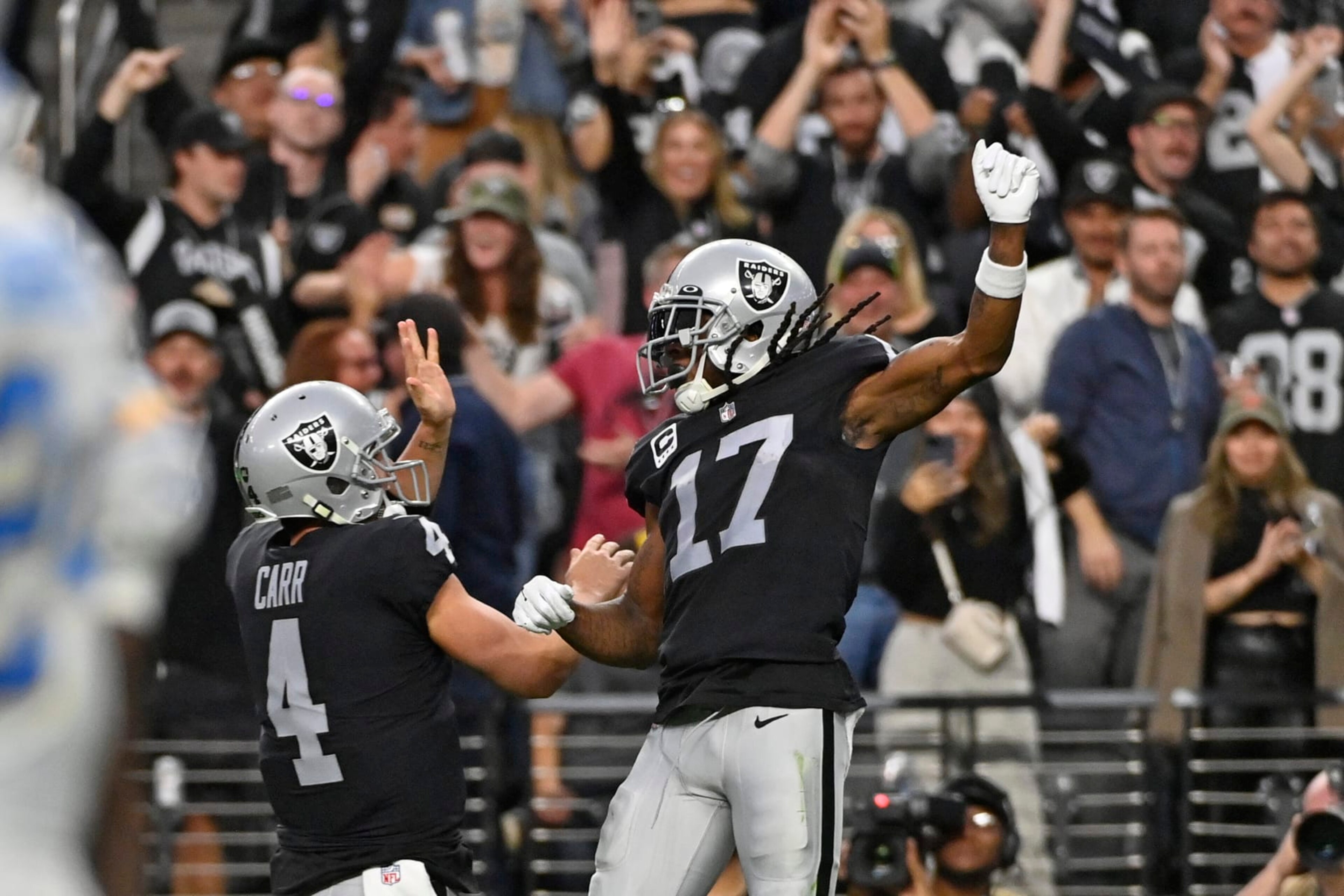Las Vegas Raiders wide receiver Davante Adams (17) celebrates his touchdown reception with quarterback Derek Carr (4) during the second half of an NFL football game, Sunday, Dec. 4, 2022, in Las Vegas. (AP Photo/David Becker)