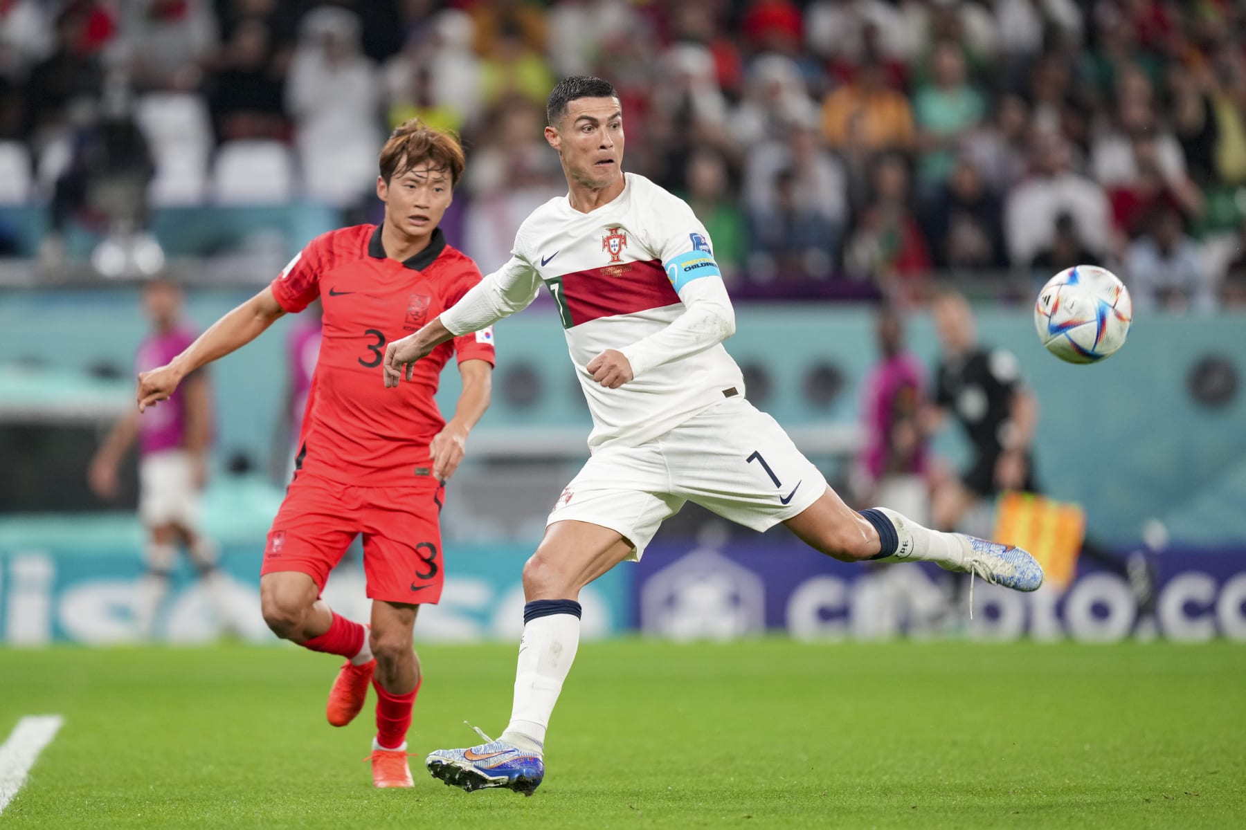 AL RAYYAN, QATAR - DECEMBER 02: Jinsu Kim of South Korea and Cristiano Ronaldo of Portugal battle for the ball during the FIFA World Cup Qatar 2022 Group H match between Korea Republic and Portugal at Education City Stadium on December 2, 2022 in Al Rayyan, Qatar. (Photo by Manuel Reino Berengui/DeFodi Images via Getty Images)