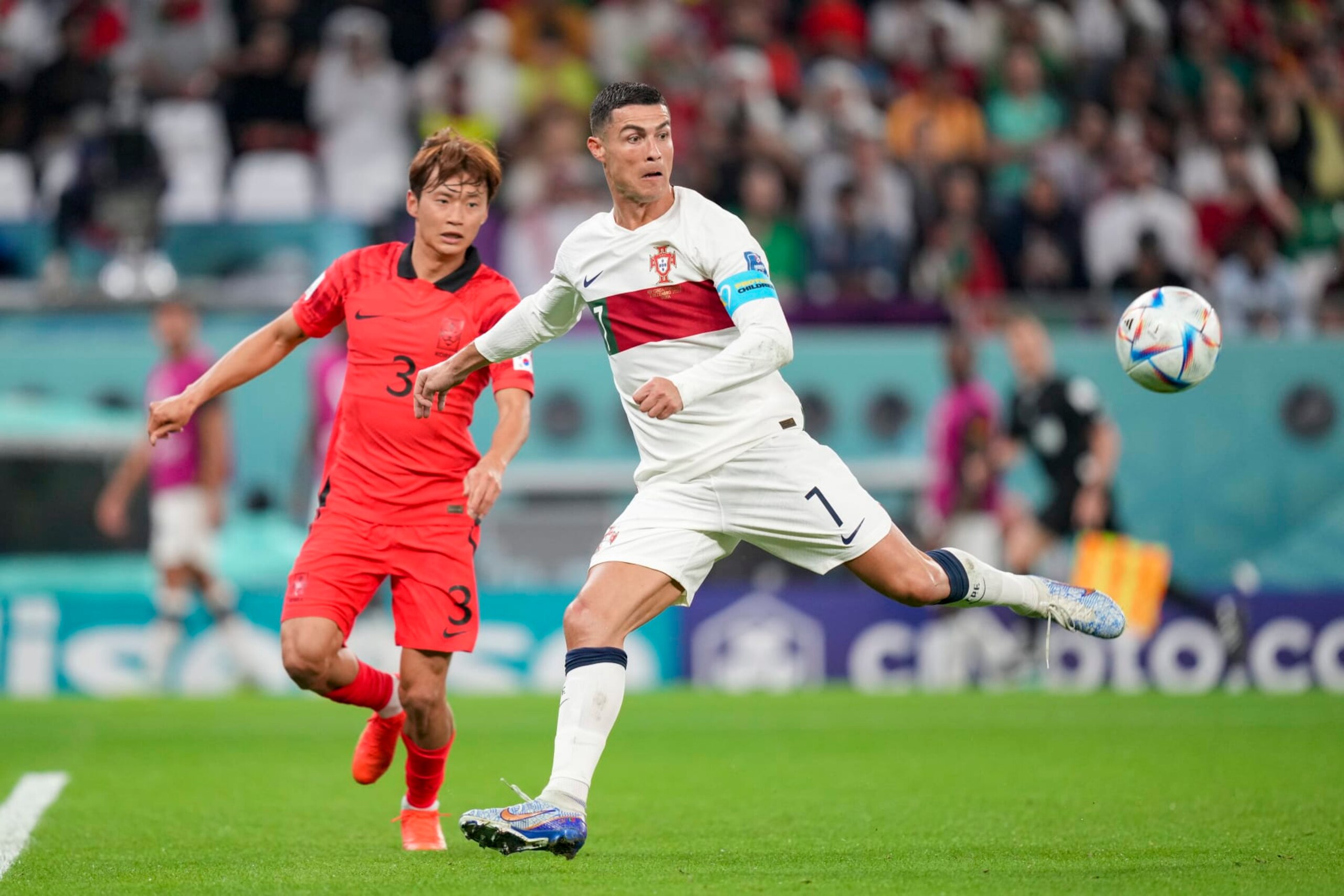 AL RAYYAN, QATAR - DECEMBER 02: Jinsu Kim of South Korea and Cristiano Ronaldo of Portugal battle for the ball during the FIFA World Cup Qatar 2022 Group H match between Korea Republic and Portugal at Education City Stadium on December 2, 2022 in Al Rayyan, Qatar. (Photo by Manuel Reino Berengui/DeFodi Images via Getty Images)