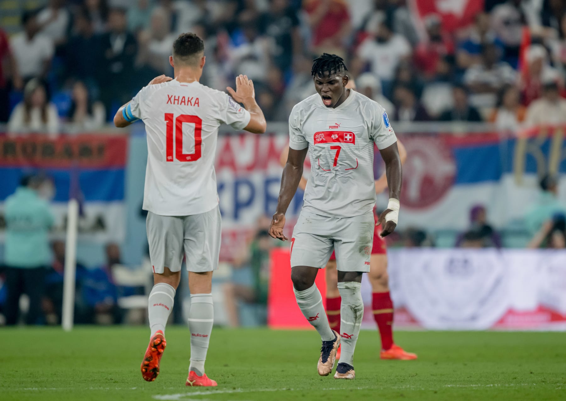 DOHA, QATAR - DECEMBER 02: Breel Embolo (R) of Switzerland celebrates after scoring his team's second goal during the FIFA World Cup Qatar 2022 Group G match between Serbia and Switzerland at Stadium 974 on December 02, 2022 in Doha, Qatar. (Photo by Marvin Ibo Guengoer - GES Sportfoto/Getty Images)