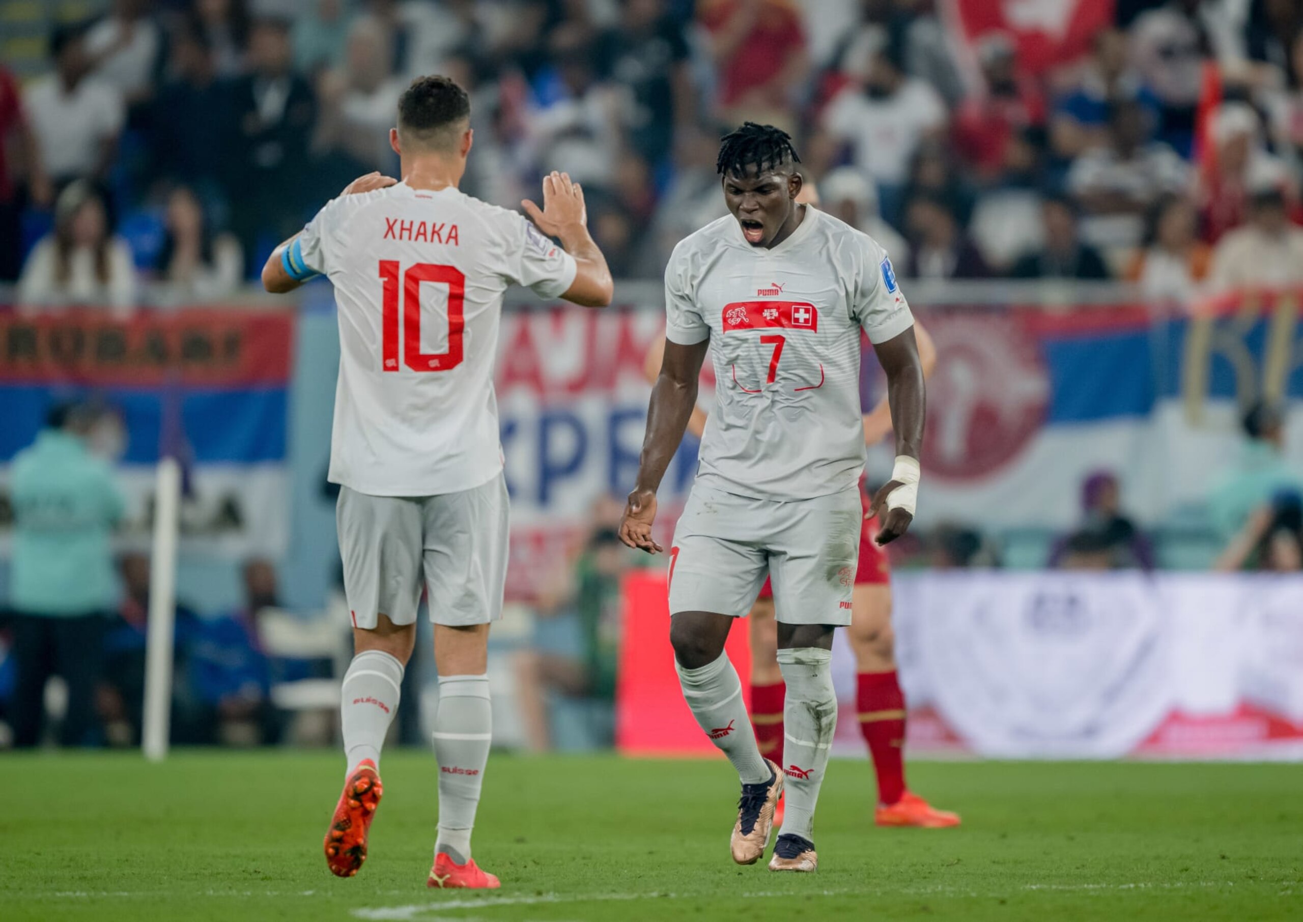 DOHA, QATAR - DECEMBER 02: Breel Embolo (R) of Switzerland celebrates after scoring his team's second goal during the FIFA World Cup Qatar 2022 Group G match between Serbia and Switzerland at Stadium 974 on December 02, 2022 in Doha, Qatar. (Photo by Marvin Ibo Guengoer - GES Sportfoto/Getty Images)