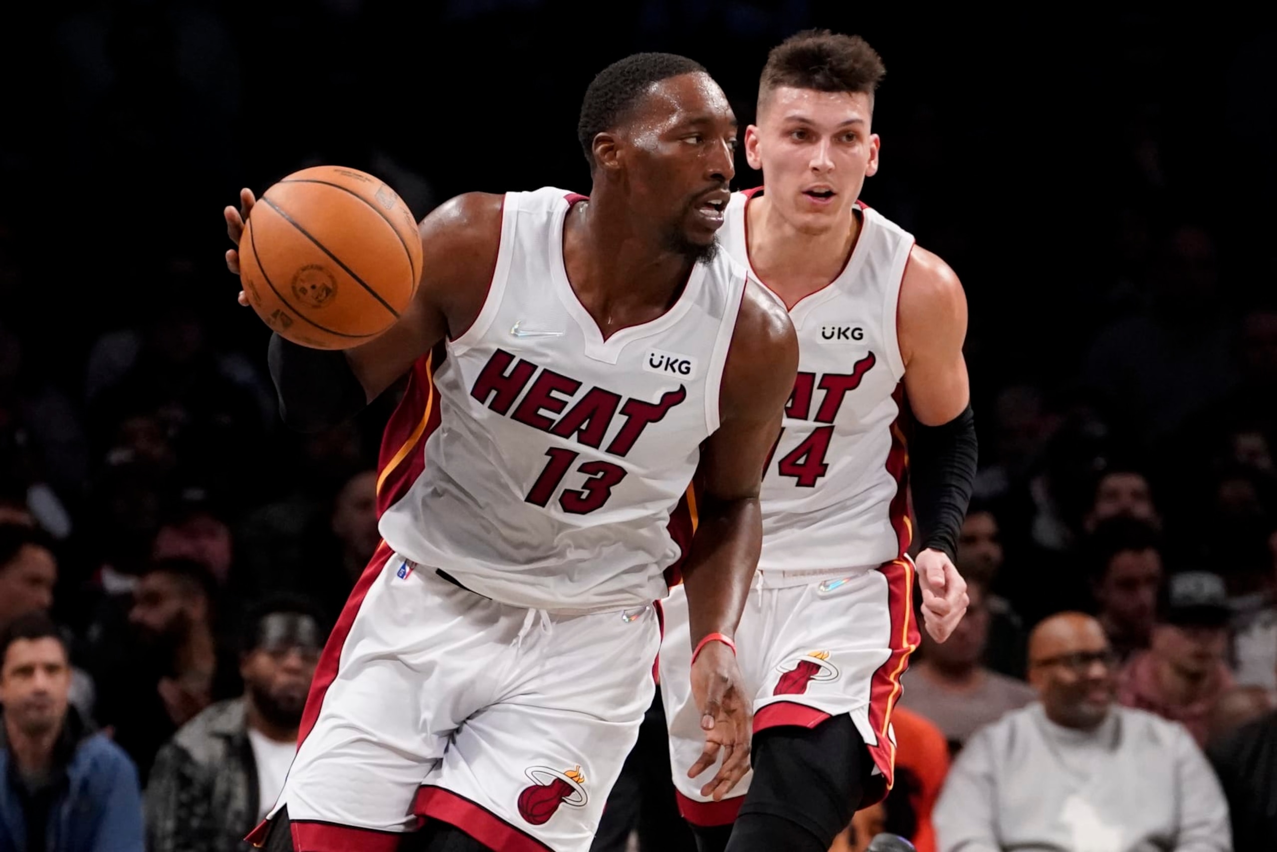 Miami Heat center Bam Adebayo (13) dribbles up the court with guard Tyler Herro (14) in tow during the first half of an NBA basketball game against the Brooklyn Nets, Wednesday, Oct. 27, 2021, in New York. (AP Photo/John Minchillo)