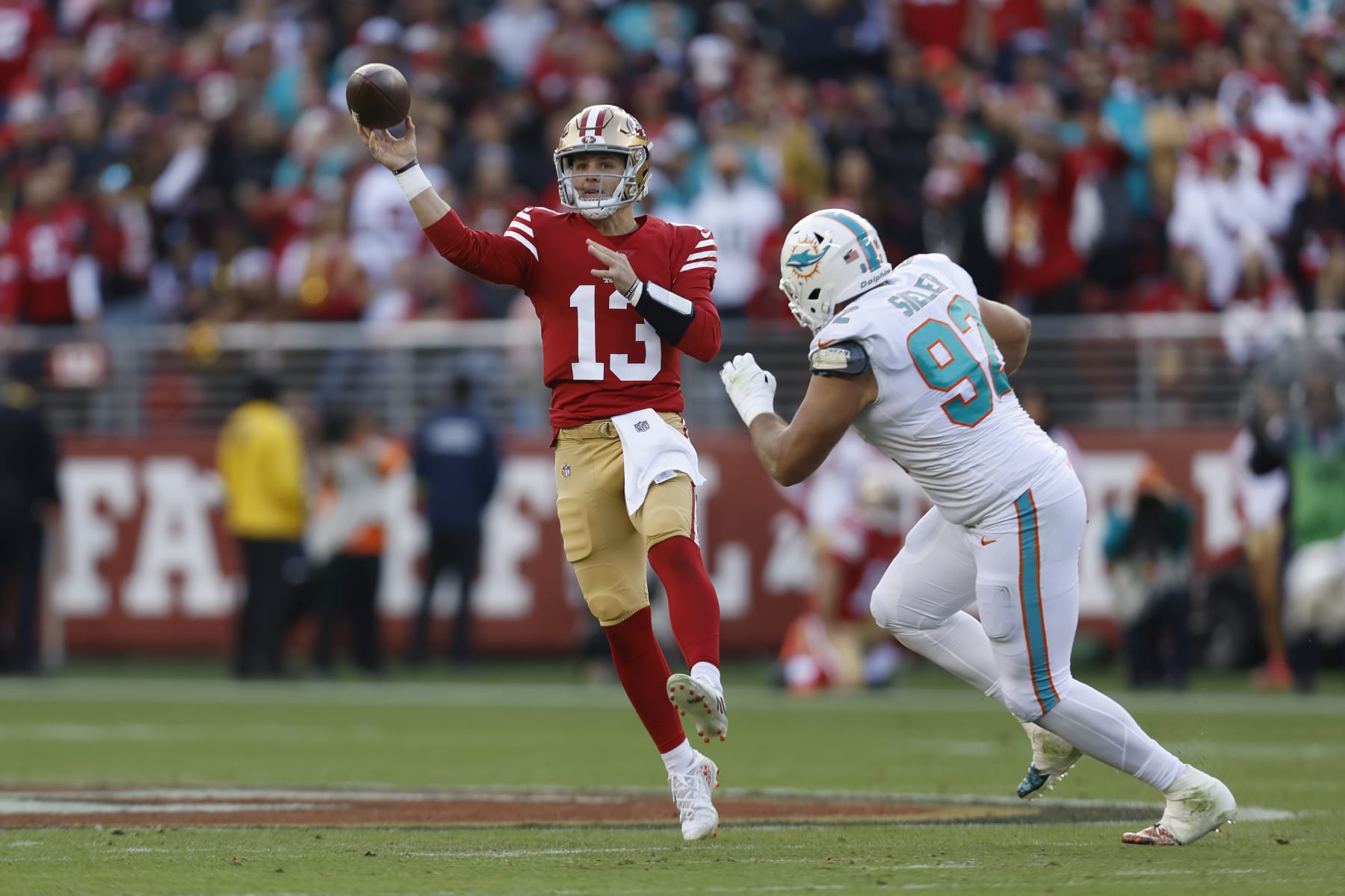 San Francisco 49ers quarterback Brock Purdy, left, passes against Miami Dolphins defensive tackle Zach Sieler during the first half of an NFL football game in Santa Clara, Calif., Sunday, Dec. 4, 2022. (AP Photo/Jed Jacobsohn)