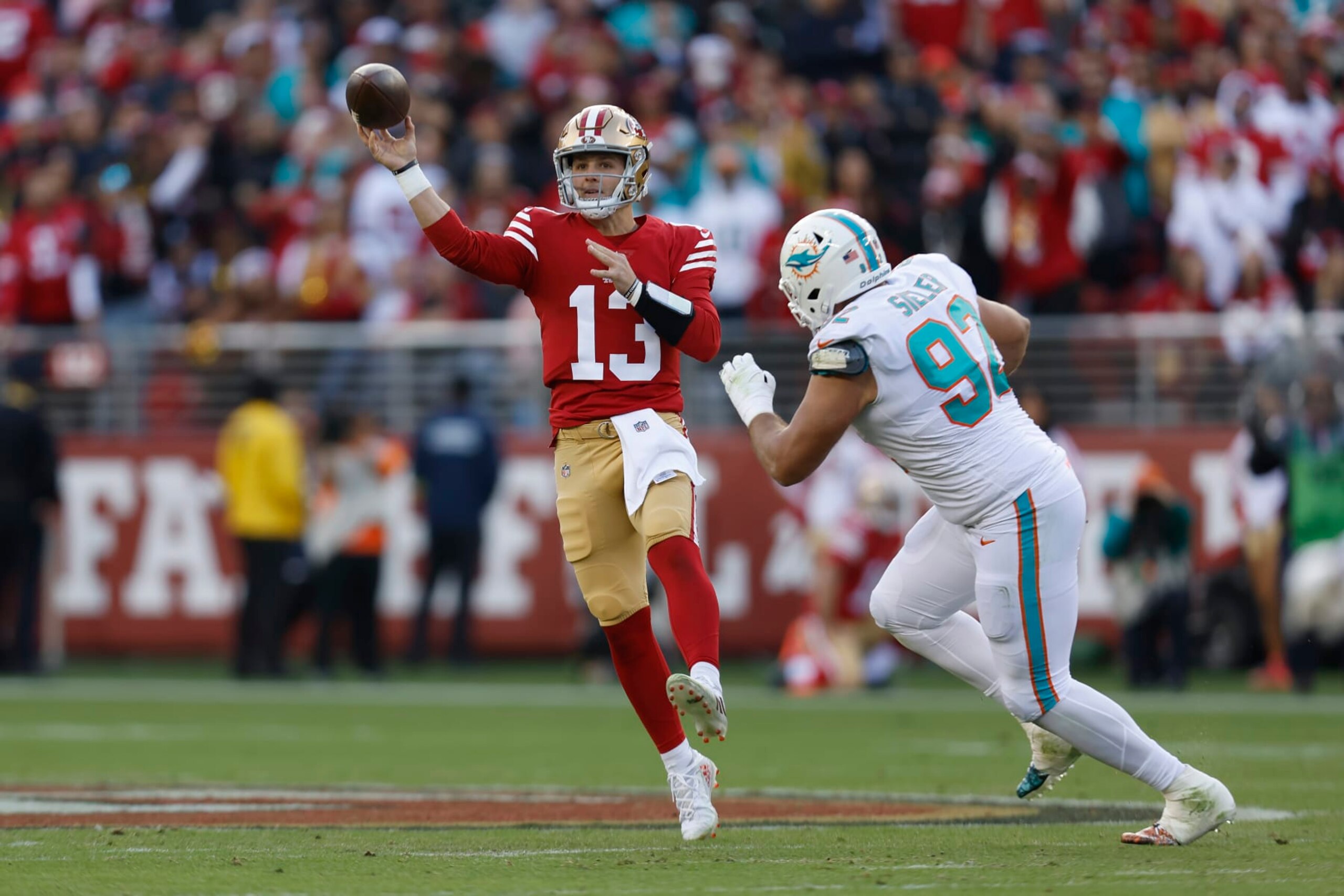 San Francisco 49ers quarterback Brock Purdy, left, passes against Miami Dolphins defensive tackle Zach Sieler during the first half of an NFL football game in Santa Clara, Calif., Sunday, Dec. 4, 2022. (AP Photo/Jed Jacobsohn)