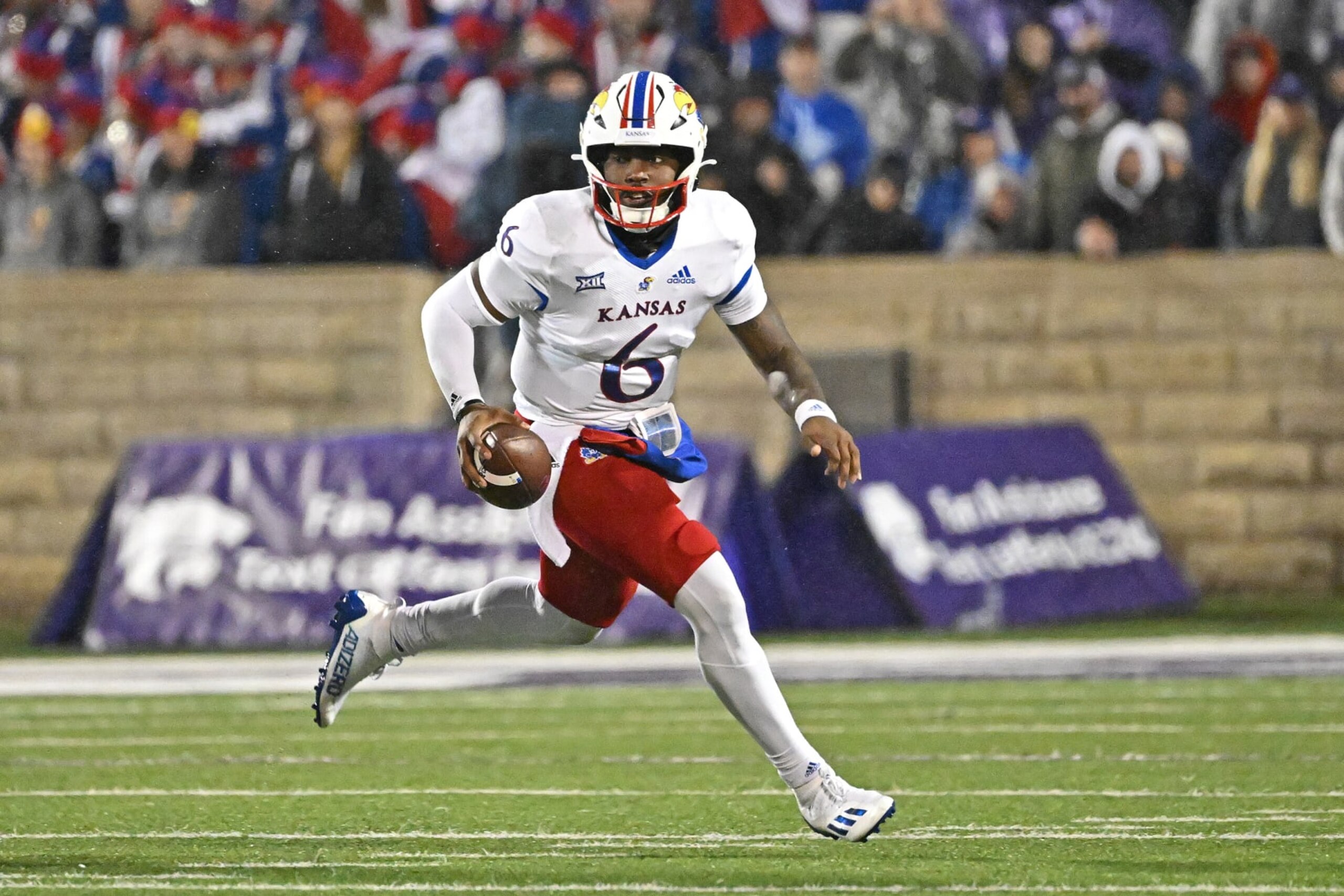 MANHATTAN, KS - NOVEMBER 26:  Quarterback Jalon Daniels #6 of the Kansas Jayhawks rolls out during the first half against the Kansas State Wildcats at Bill Snyder Family Football Stadium on November 26, 2022 in Manhattan, Kansas. (Photo by Peter G. Aiken/Getty Images)