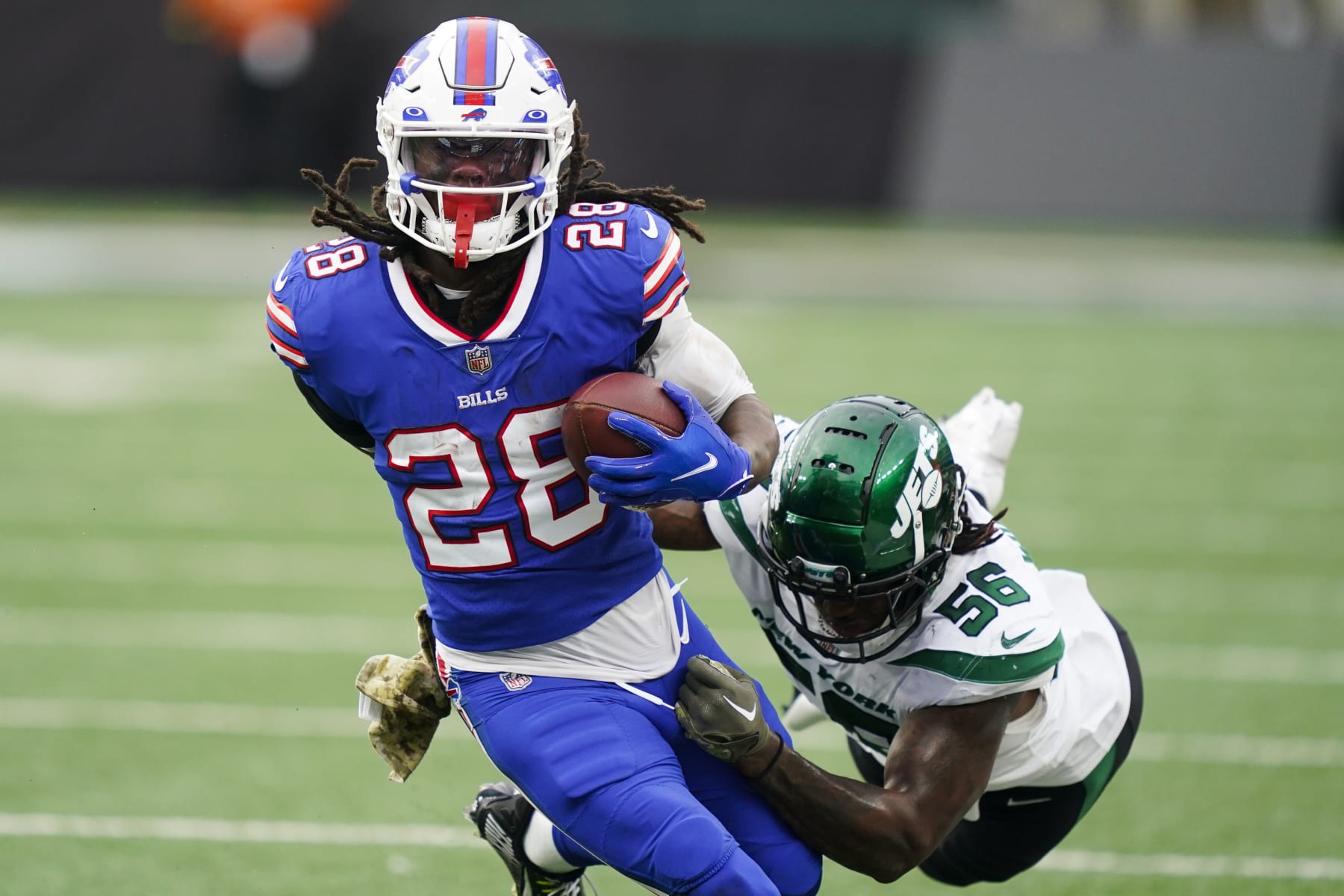 Buffalo Bills running back James Cook (28) breaks a tackle by New York Jets' Quincy Williams (56) during the second half of an NFL football game, Sunday, Nov. 6, 2022, in East Rutherford, N.J. (AP Photo/John Minchillo) Buffalo Bills running back James Cook (28) breaks a tackle by New York Jets' Quincy Williams (56) during the second half of an NFL football game, Sunday, Nov. 6, 2022, in East Rutherford, N.J. (AP Photo/John Minchillo)