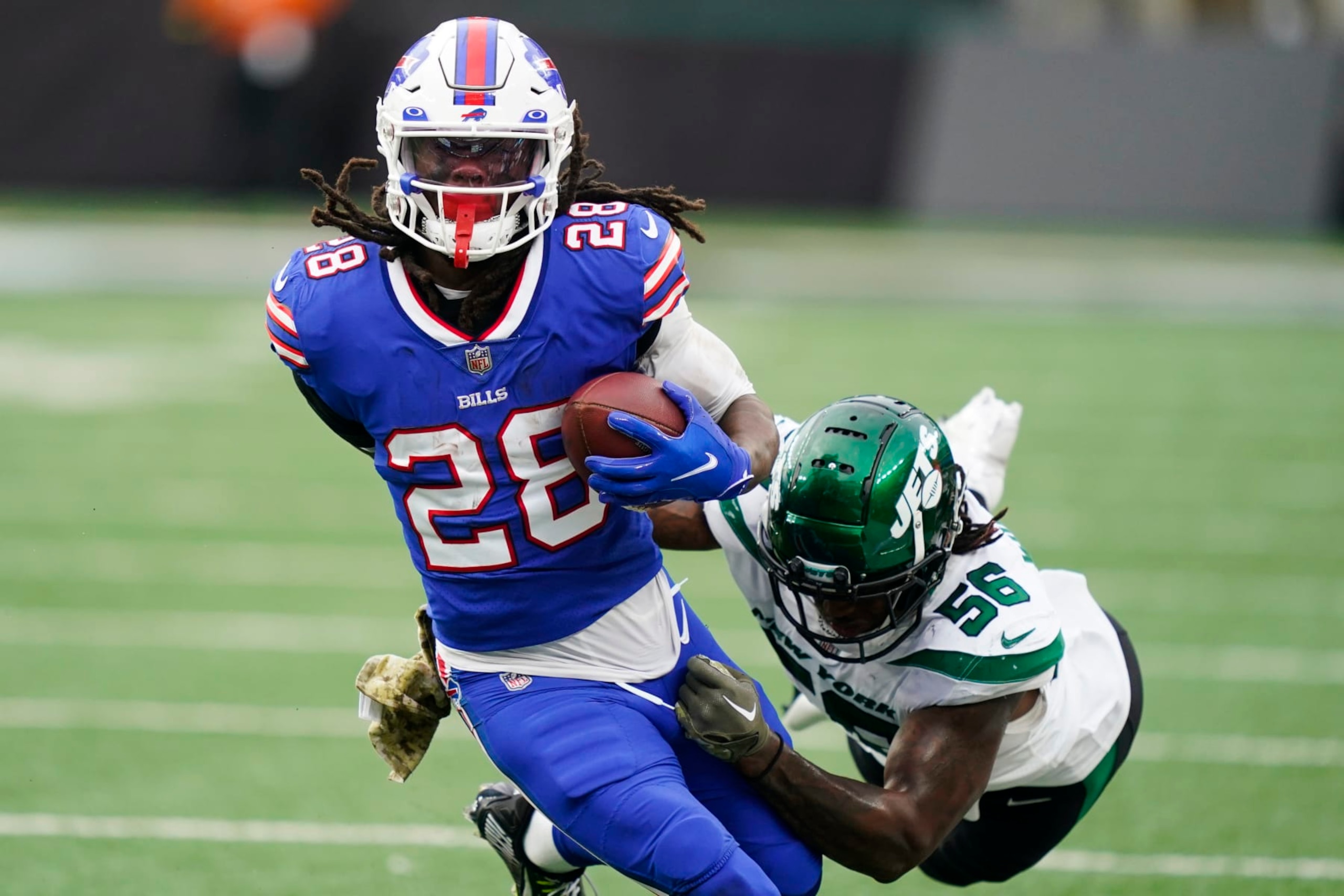 Buffalo Bills running back James Cook (28) breaks a tackle by New York Jets' Quincy Williams (56) during the second half of an NFL football game, Sunday, Nov. 6, 2022, in East Rutherford, N.J. (AP Photo/John Minchillo) Buffalo Bills running back James Cook (28) breaks a tackle by New York Jets' Quincy Williams (56) during the second half of an NFL football game, Sunday, Nov. 6, 2022, in East Rutherford, N.J. (AP Photo/John Minchillo)