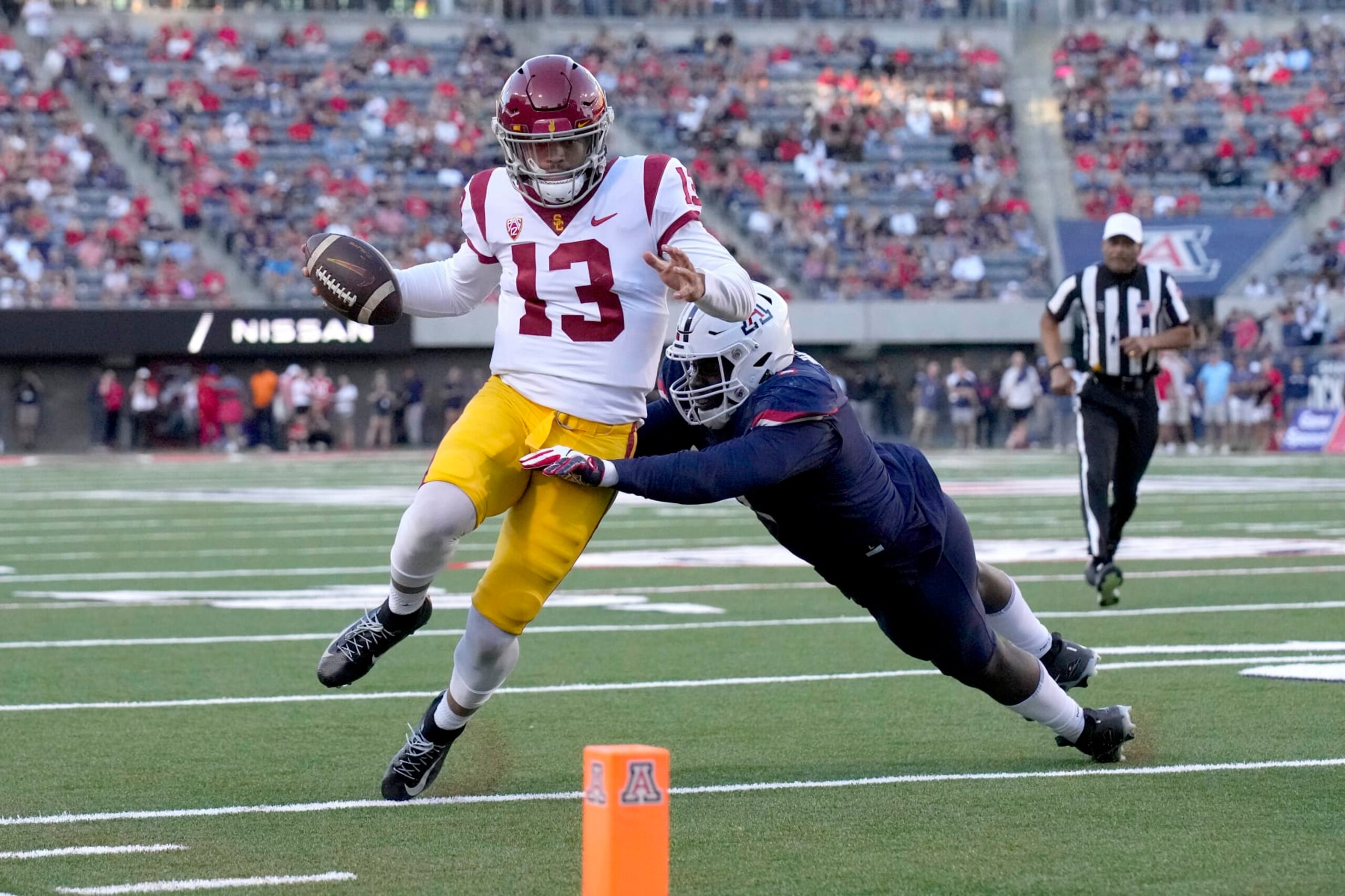Southern California quarterback Caleb Williams (13) tries to score against Arizona defensive lineman Jalen Harris in the first half during an NCAA college football game, Saturday, Oct. 29, 2022, in Tucson, Ariz. (AP Photo/Rick Scuteri) Southern California quarterback Caleb Williams (13) tries to score against Arizona defensive lineman Jalen Harris in the first half during an NCAA college football game, Saturday, Oct. 29, 2022, in Tucson, Ariz. (AP Photo/Rick Scuteri)