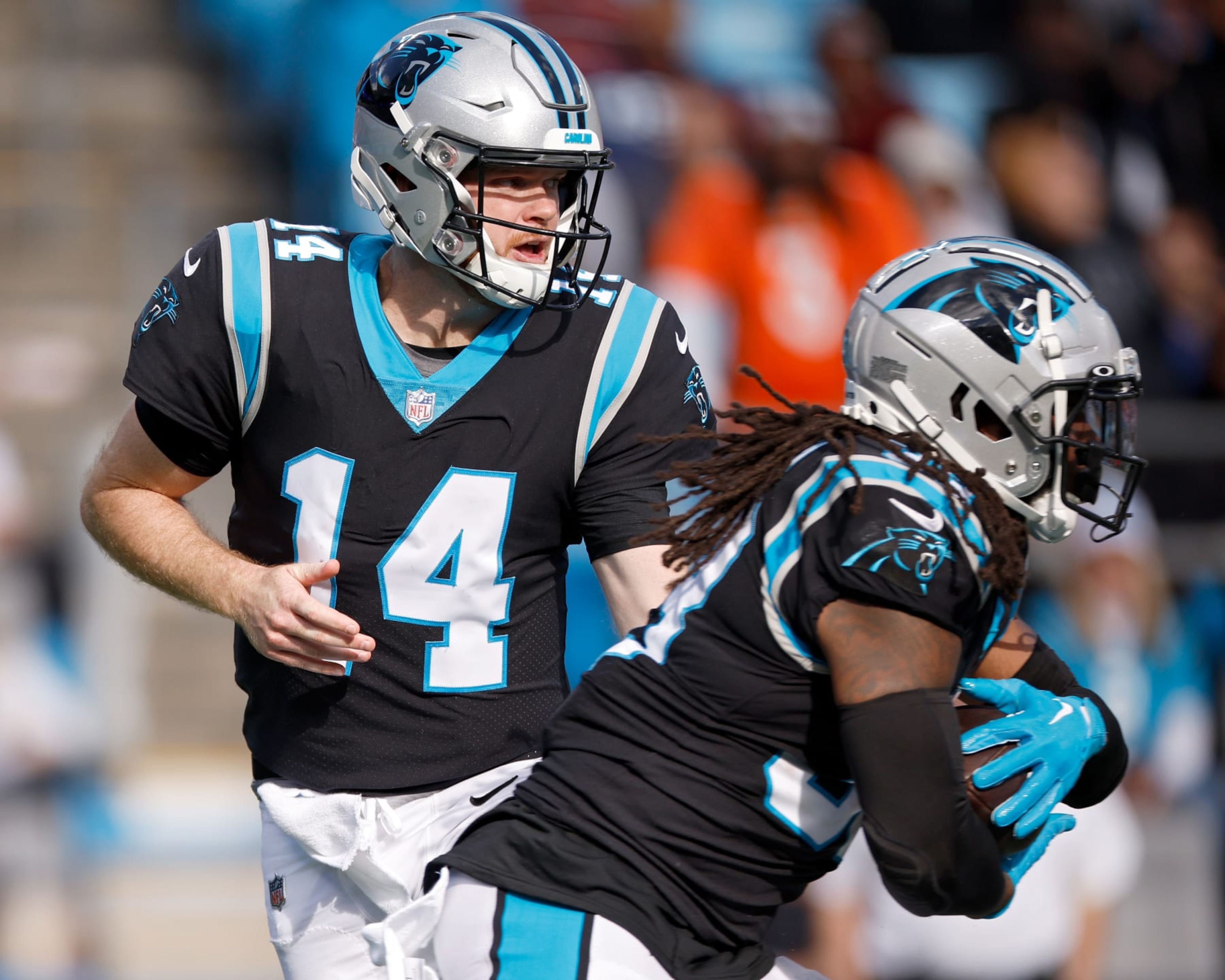 CHARLOTTE, NORTH CAROLINA - NOVEMBER 27: Sam Darnold #14 of the Carolina Panthers hands the ball to D'Onta Foreman #33 during the second half against the Denver Broncos at Bank of America Stadium on November 27, 2022 in Charlotte, North Carolina. (Photo by Jared C. Tilton/Getty Images)