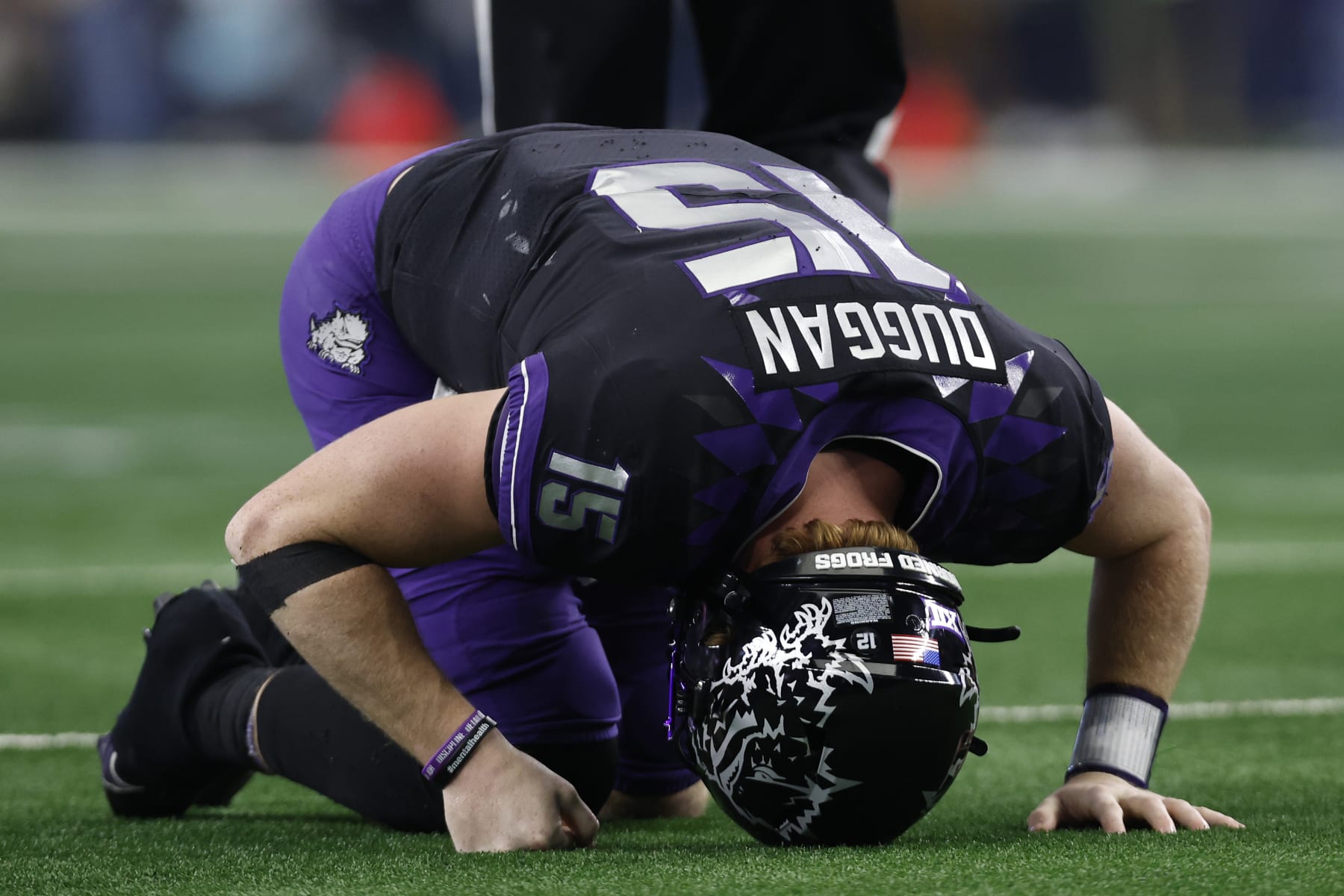 ARLINGTON, TEXAS - DECEMBER 03: Quarterback Max Duggan #15 of the TCU Horned Frogs reacts after being hit after a pass in the second half against the Kansas State Wildcats at AT&T Stadium on December 03, 2022 in Arlington, Texas. (Photo by Tim Heitman/Getty Images)