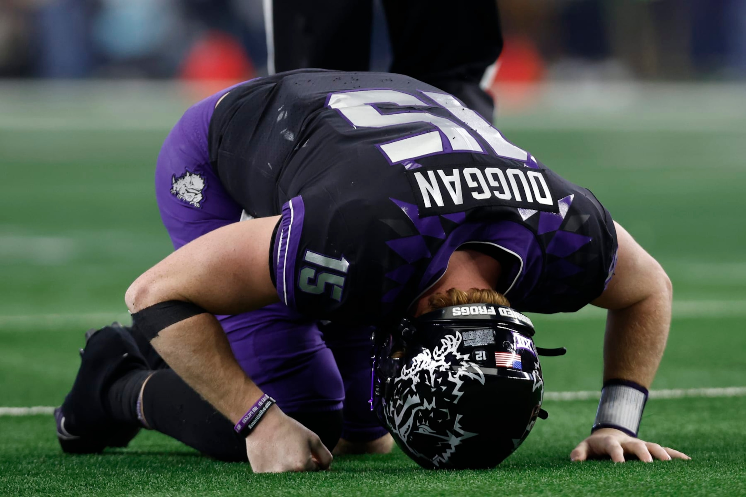 ARLINGTON, TEXAS - DECEMBER 03: Quarterback Max Duggan #15 of the TCU Horned Frogs reacts after being hit after a pass in the second half against the Kansas State Wildcats at AT&T Stadium on December 03, 2022 in Arlington, Texas. (Photo by Tim Heitman/Getty Images)