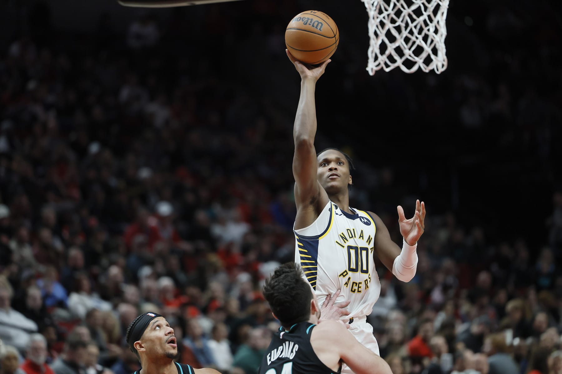 PORTLAND, OREGON - DECEMBER 04: Bennedict Mathurin #00 of the Indiana Pacers shoots the ball against Drew Eubanks #24 of the Portland Trail Blazers during the second half at Moda Center on December 04, 2022 in Portland, Oregon. NOTE TO USER: User expressly acknowledges and agrees that, by downloading and or using this photograph, User is consenting to the terms and conditions of the Getty Images License Agreement. (Photo by Soobum Im/Getty Images)
