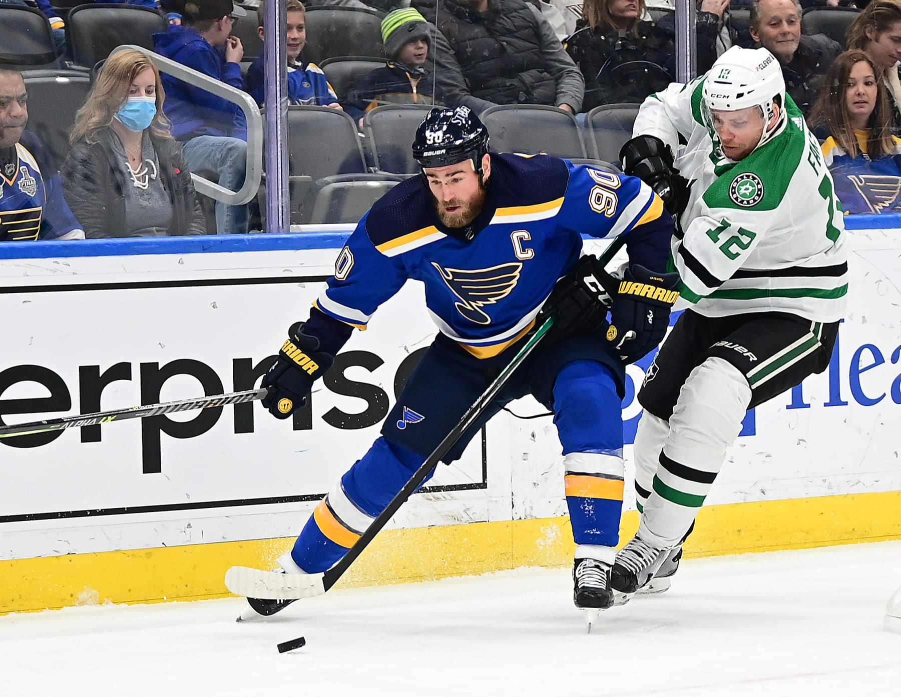 ST. LOUIS, MO - JANUARY 09: St. Louis Blues center Ryan O'Reilly (90) competes for a loose puck with Dallas Stars center Radek Faksa (12) during a NHL game between the Dallas Stars and the St. Louis Blues on January 09, 2022, at Enterprise Center, St. Louis, MO.  (Photo by Keith Gillett/Icon Sportswire via Getty Images),