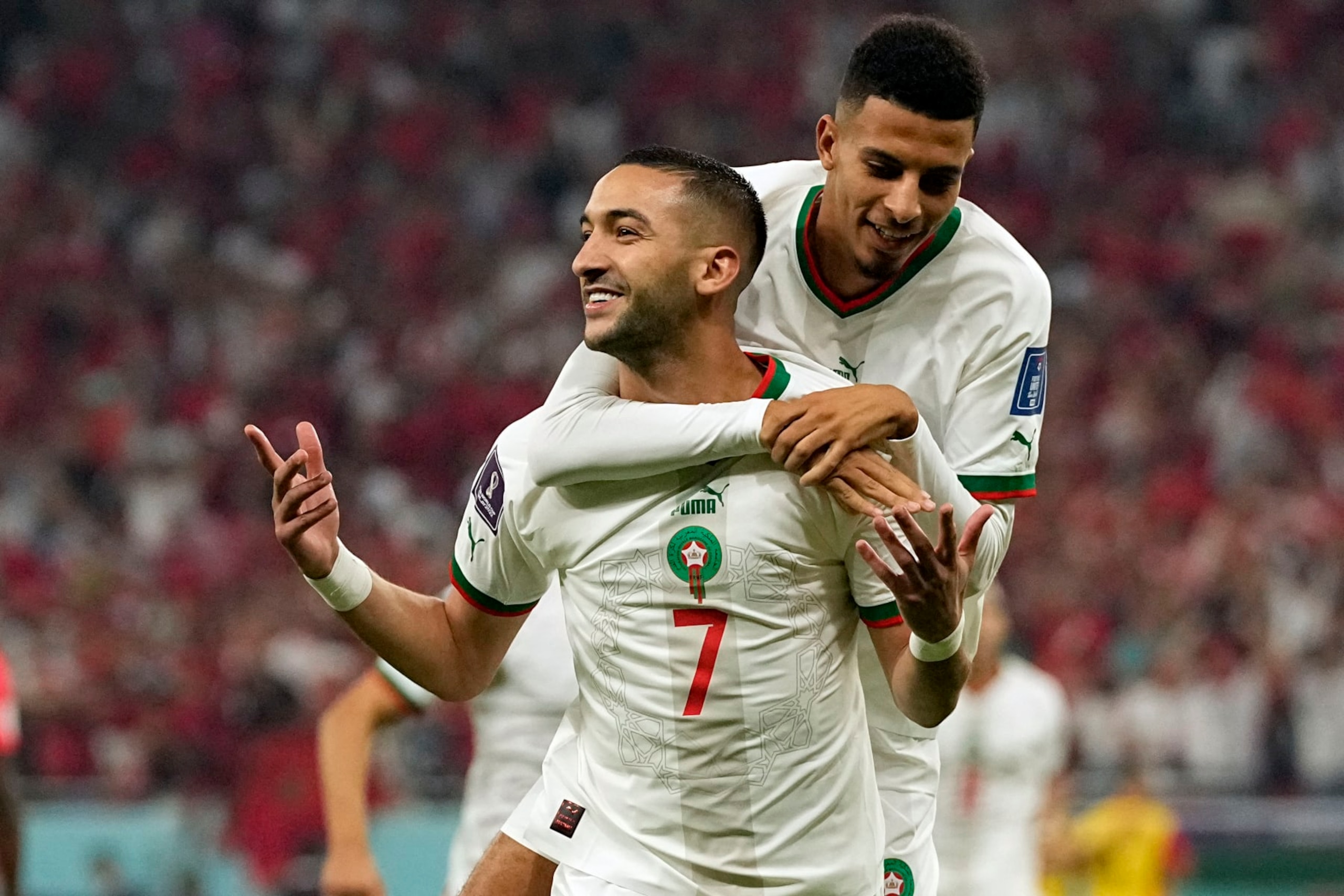 Morocco's Hakim Ziyech, foreground, celebrates after scoring his side's opening goal besides team mate Azzedine Ounahi during the World Cup group F soccer match between Canada and Morocco at the Al Thumama Stadium in Doha , Qatar, Thursday, Dec. 1, 2022. (AP Photo/Pavel Golovkin)