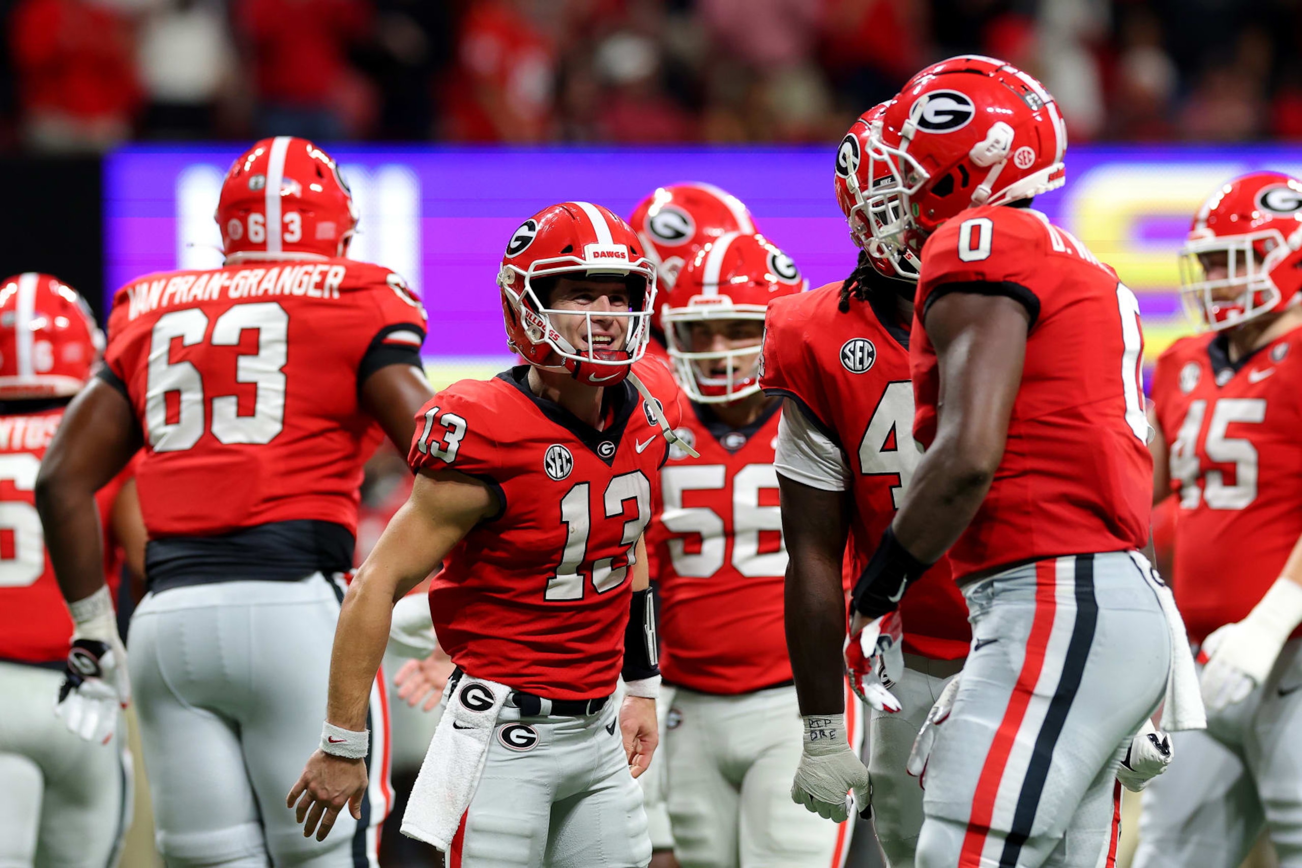 ATLANTA, GEORGIA - DECEMBER 03: Stetson Bennett #13 and Darnell Washington #0 of the Georgia Bulldogs celebrate after scoring a touchdown against the LSU Tigers during the second quarter in the SEC Championship game at Mercedes-Benz Stadium on December 03, 2022 in Atlanta, Georgia. (Photo by Kevin C. Cox/Getty Images) ATLANTA, GEORGIA - DECEMBER 03: Stetson Bennett #13 and Darnell Washington #0 of the Georgia Bulldogs celebrate after scoring a touchdown against the LSU Tigers during the second quarter in the SEC Championship game at Mercedes-Benz Stadium on December 03, 2022 in Atlanta, Georgia. (Photo by Kevin C. Cox/Getty Images)
