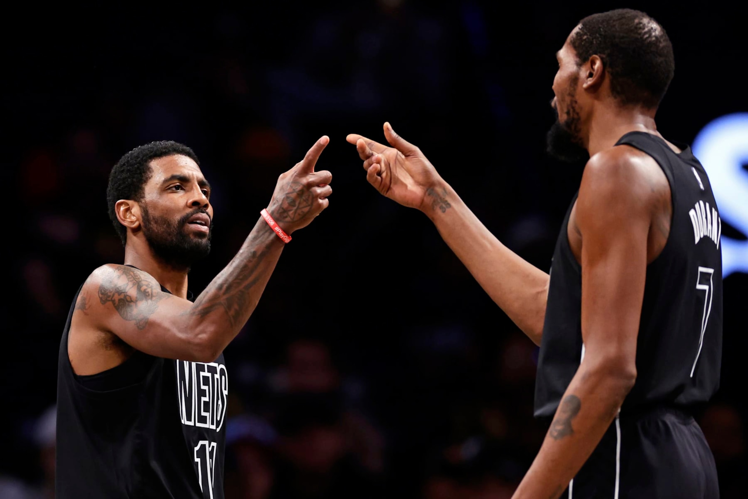 NEW YORK, NEW YORK - DECEMBER 2: Kyrie Irving #11 of the Brooklyn Nets reacts with teammate Kevin Durant #7 against the Toronto Raptors during the second half at Barclays Center on December 2, 2022 in New York City. The Nets won 114-105. NOTE TO USER: User expressly acknowledges and agrees that, by downloading and or using this Photograph, user is consenting to the terms and conditions of the Getty Images License Agreement. (Photo by Adam Hunger/Getty Images) NEW YORK, NEW YORK - DECEMBER 2: Kyrie Irving #11 of the Brooklyn Nets reacts with teammate Kevin Durant #7 against the Toronto Raptors during the second half at Barclays Center on December 2, 2022 in New York City. The Nets won 114-105. NOTE TO USER: User expressly acknowledges and agrees that, by downloading and or using this Photograph, user is consenting to the terms and conditions of the Getty Images License Agreement. (Photo by Adam Hunger/Getty Images)