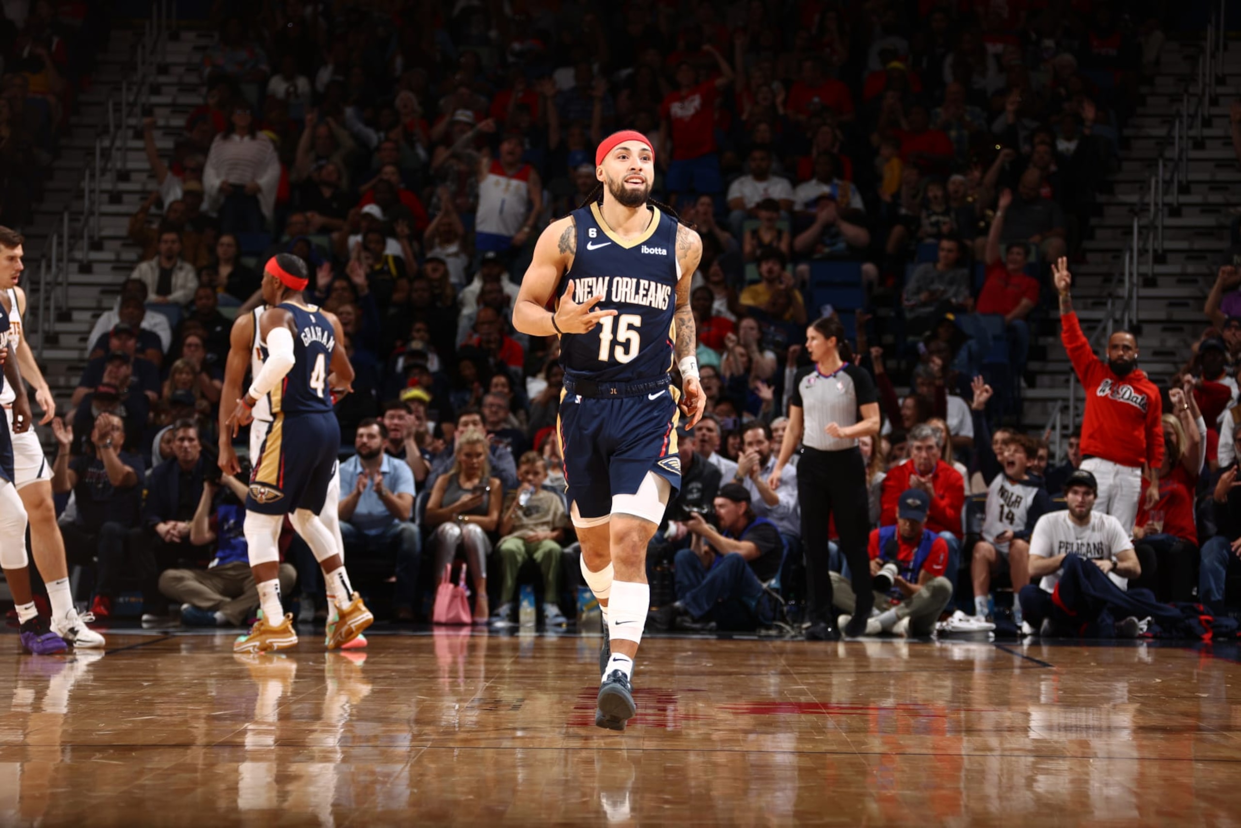 NEW ORLEANS, LA - DECEMBER 4: New Orleans Pelicans fans celebrate a three point basket by Jose Alvarado #15 as he runs up the court on December 4, 2022 at the Smoothie King Center in New Orleans, Louisiana. NOTE TO USER: User expressly acknowledges and agrees that, by downloading and or using this Photograph, user is consenting to the terms and conditions of the Getty Images License Agreement. Mandatory Copyright Notice: Copyright 2022 NBAE (Photo by Ned Dishman/NBAE via Getty Images) NEW ORLEANS, LA - DECEMBER 4: New Orleans Pelicans fans celebrate a three point basket by Jose Alvarado #15 as he runs up the court on December 4, 2022 at the Smoothie King Center in New Orleans, Louisiana. NOTE TO USER: User expressly acknowledges and agrees that, by downloading and or using this Photograph, user is consenting to the terms and conditions of the Getty Images License Agreement. Mandatory Copyright Notice: Copyright 2022 NBAE (Photo by Ned Dishman/NBAE via Getty Images)