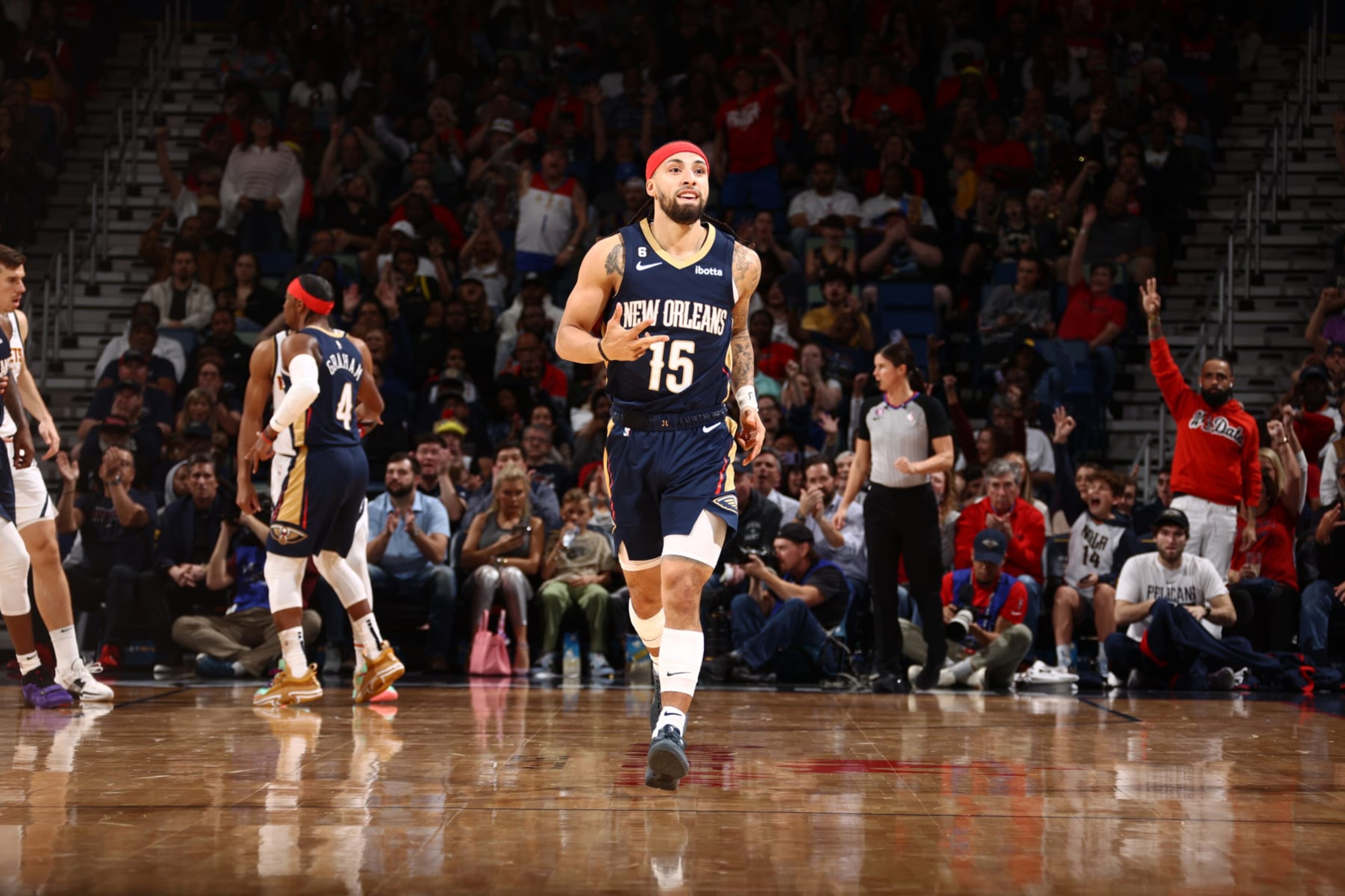 NEW ORLEANS, LA - DECEMBER 4: New Orleans Pelicans fans celebrate a three point basket by Jose Alvarado #15 as he runs up the court on December 4, 2022 at the Smoothie King Center in New Orleans, Louisiana. NOTE TO USER: User expressly acknowledges and agrees that, by downloading and or using this Photograph, user is consenting to the terms and conditions of the Getty Images License Agreement. Mandatory Copyright Notice: Copyright 2022 NBAE (Photo by Ned Dishman/NBAE via Getty Images)