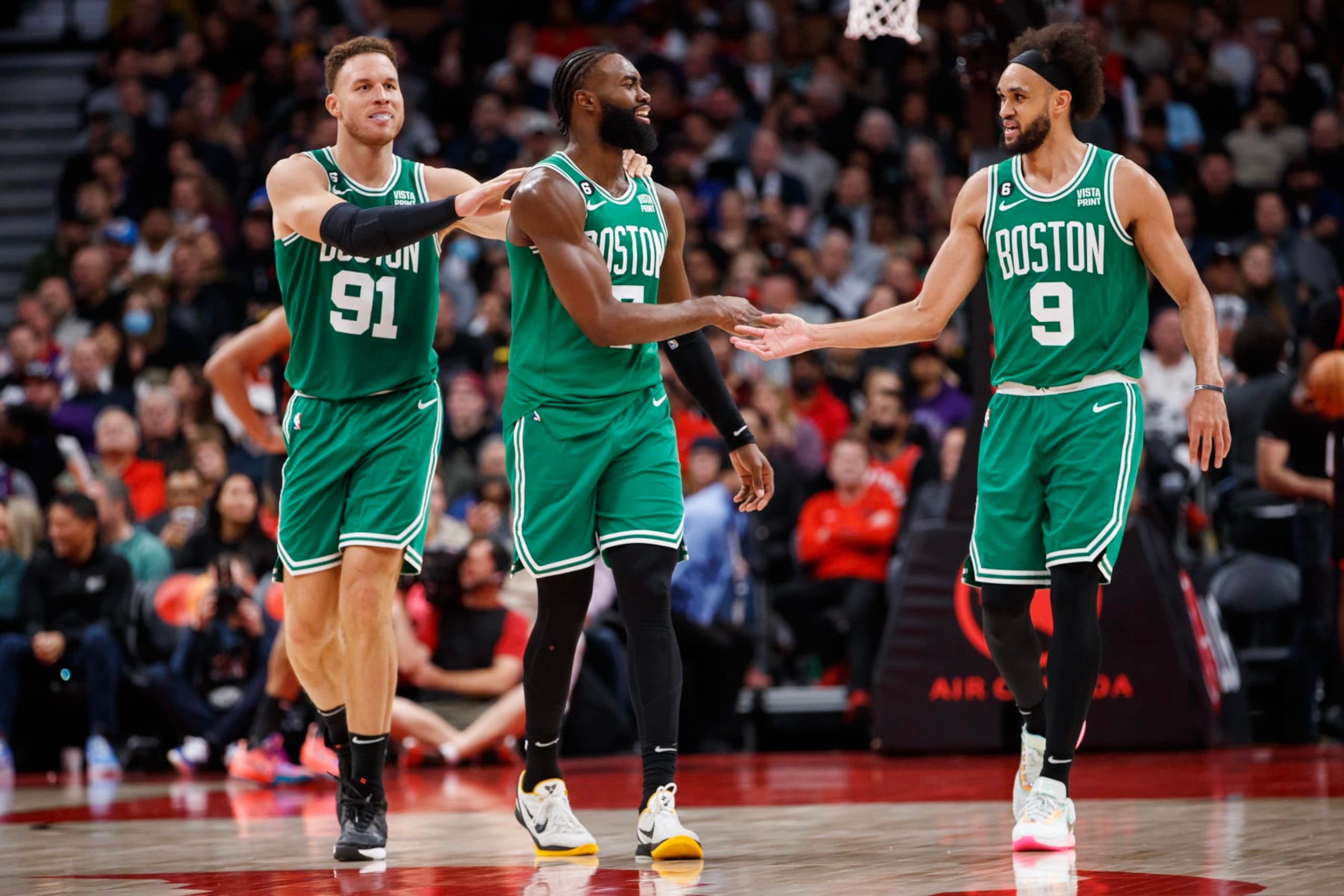 TORONTO, ON - DECEMBER 05: Blake Griffin #91, Jaylen Brown #7 and Derrick White #9 of the Boston Celtics celebrate in the final minutes of the second half of their NBA game against the Toronto Raptors at Scotiabank Arena on December 5, 2022 in Toronto, Canada. NOTE TO USER: User expressly acknowledges and agrees that, by downloading and or using this photograph, User is consenting to the terms and conditions of the Getty Images License Agreement. (Photo by Cole Burston/Getty Images) TORONTO, ON - DECEMBER 05: Blake Griffin #91, Jaylen Brown #7 and Derrick White #9 of the Boston Celtics celebrate in the final minutes of the second half of their NBA game against the Toronto Raptors at Scotiabank Arena on December 5, 2022 in Toronto, Canada. NOTE TO USER: User expressly acknowledges and agrees that, by downloading and or using this photograph, User is consenting to the terms and conditions of the Getty Images License Agreement. (Photo by Cole Burston/Getty Images)