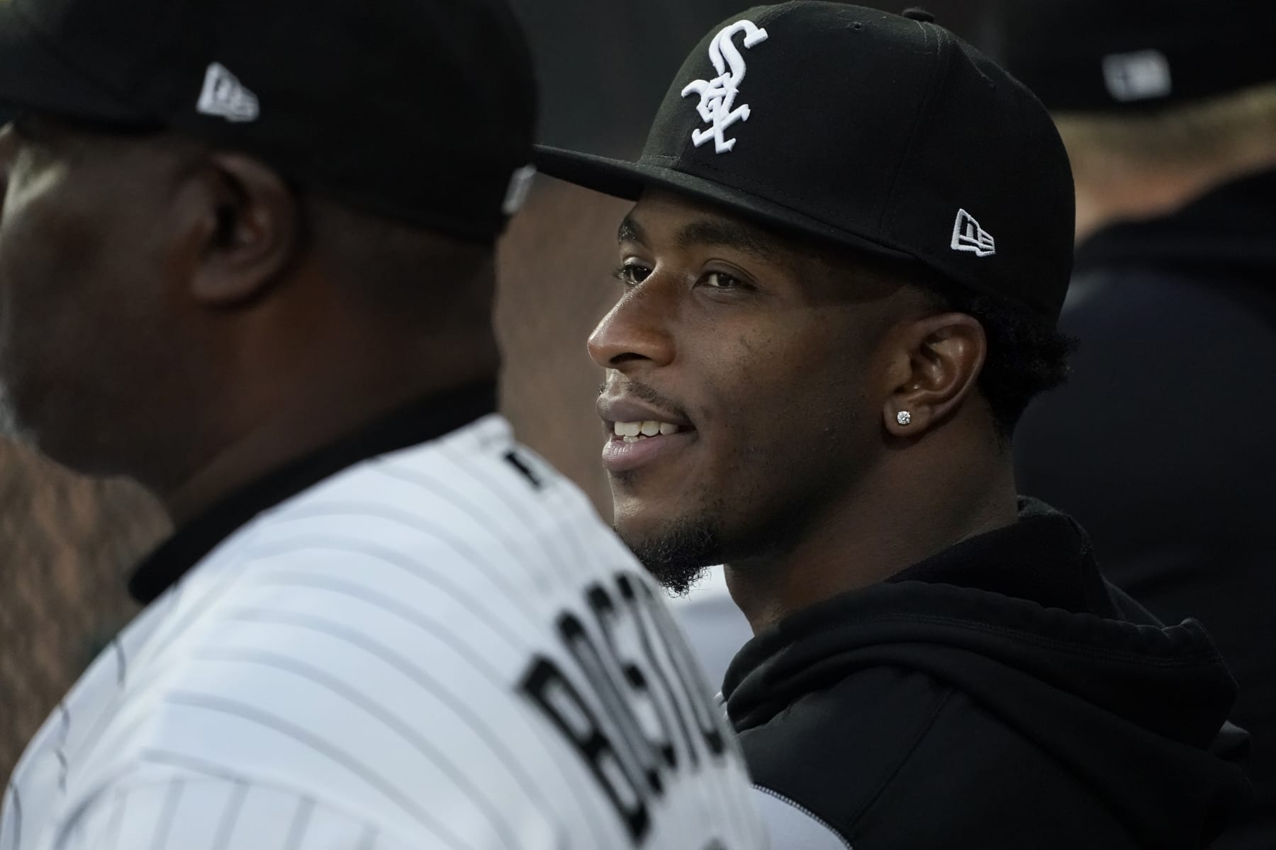 Chicago White Sox's Tim Anderson smiles as he sits in the dugout during the first inning of a baseball game against the Detroit Tigers Saturday, Sept. 24, 2022, in Chicago. (AP Photo/Charles Rex Arbogast)