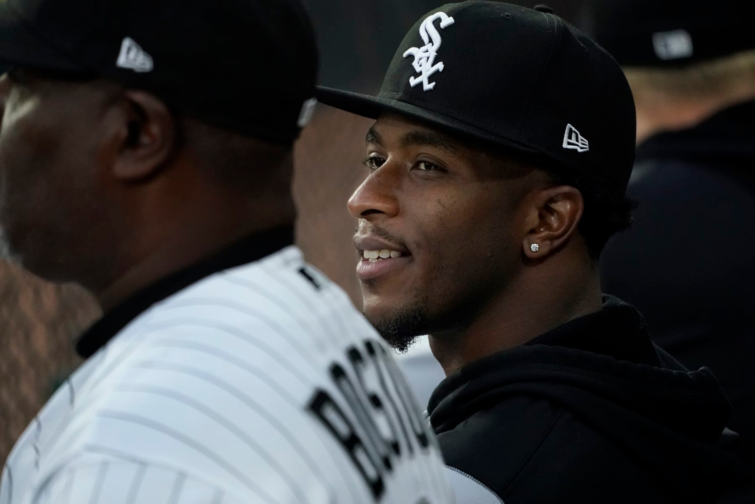 Chicago White Sox's Tim Anderson smiles as he sits in the dugout during the first inning of a baseball game against the Detroit Tigers Saturday, Sept. 24, 2022, in Chicago. (AP Photo/Charles Rex Arbogast)