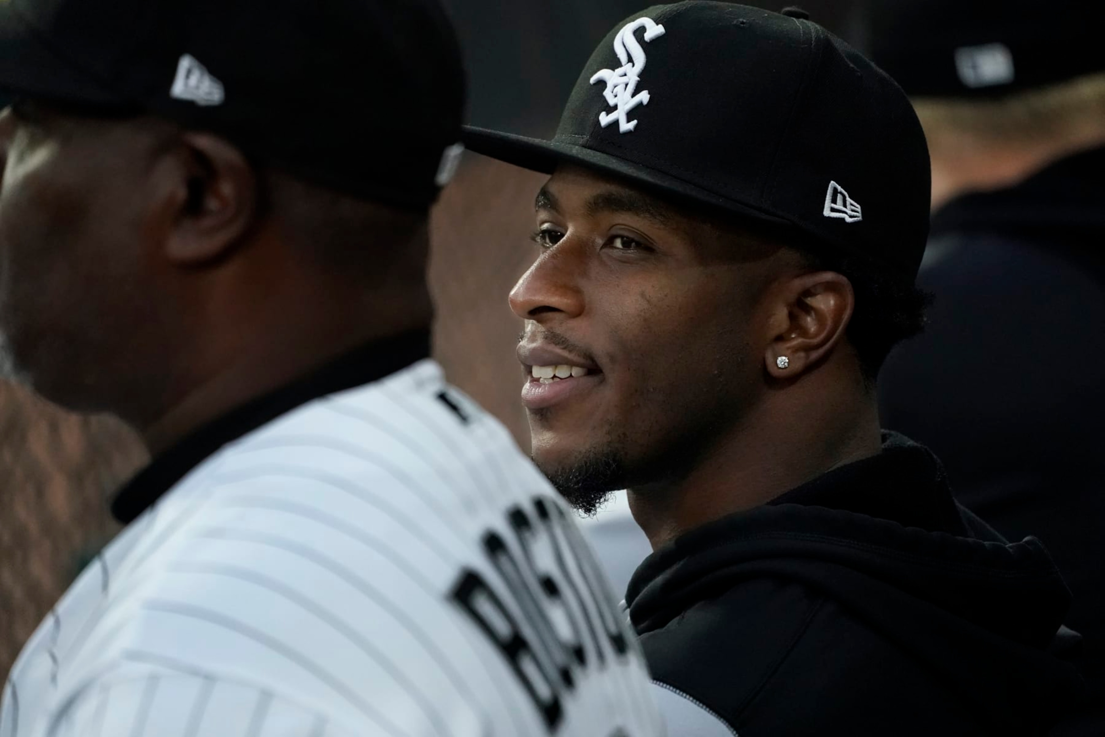 Chicago White Sox's Tim Anderson smiles as he sits in the dugout during the first inning of a baseball game against the Detroit Tigers Saturday, Sept. 24, 2022, in Chicago. (AP Photo/Charles Rex Arbogast)