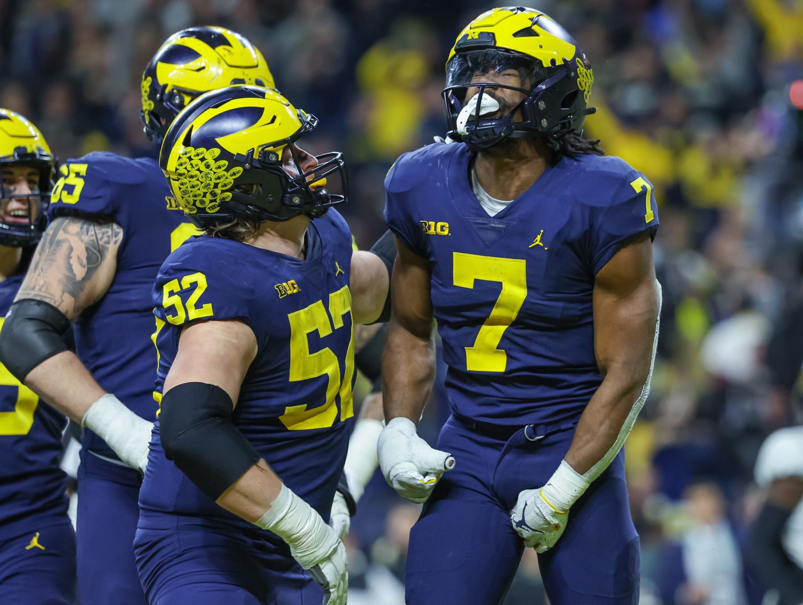 INDIANAPOLIS, IN - DECEMBER 04: Members of the Michigan Wolverines celebrate with Donovan Edwards #7 of the Michigan Wolverines after a touchdown during the second half of the Big Ten Championship against the Purdue Boilermakers at Lucas Oil Stadium on December 3, 2022 in Indianapolis, Indiana. (Photo by Michael Hickey/Getty Images)