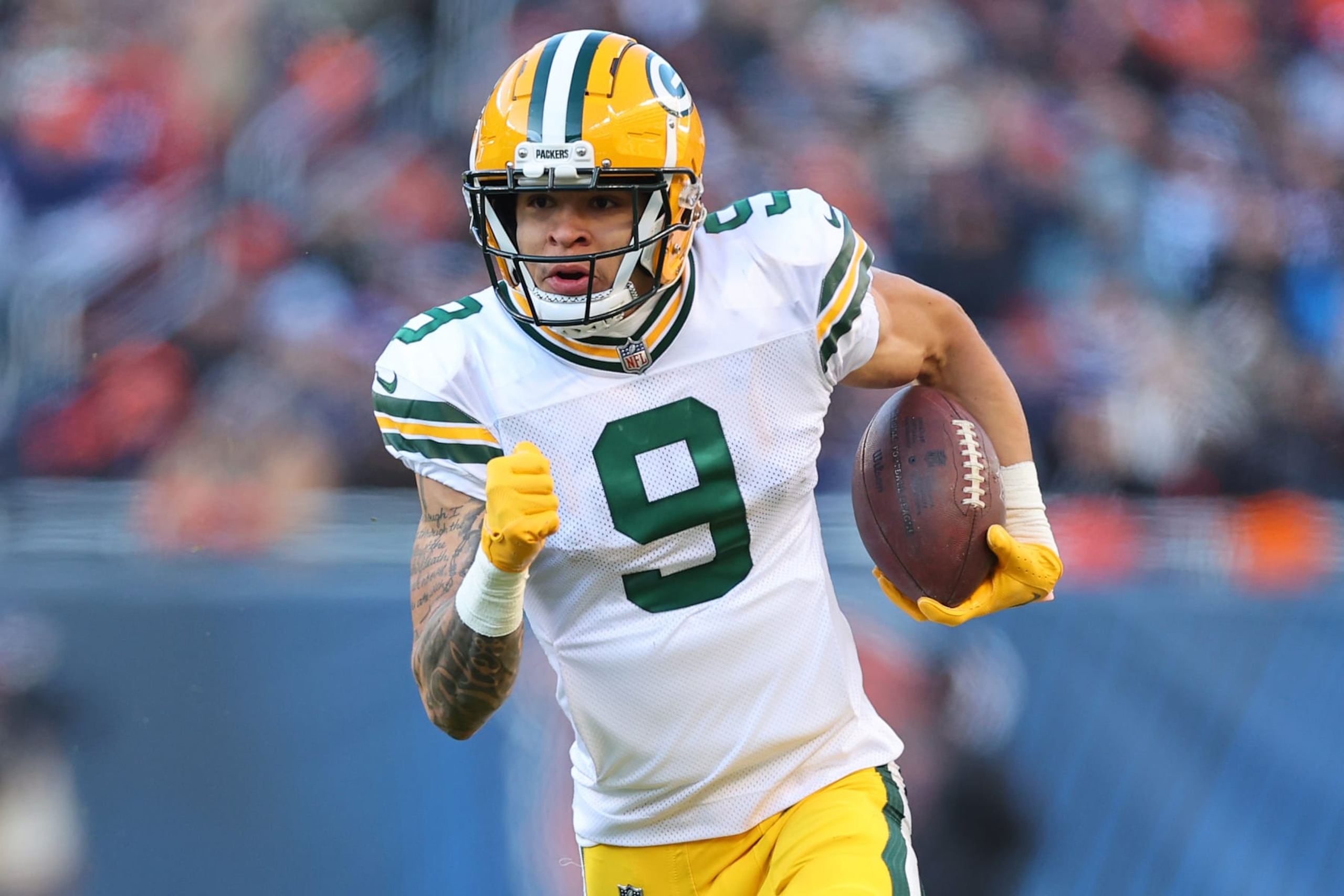 CHICAGO, ILLINOIS - DECEMBER 04: Christian Watson #9 of the Green Bay Packers runs for a touchdown against the Chicago Bears during the fourth quarter at Soldier Field on December 04, 2022 in Chicago, Illinois. (Photo by Michael Reaves/Getty Images)