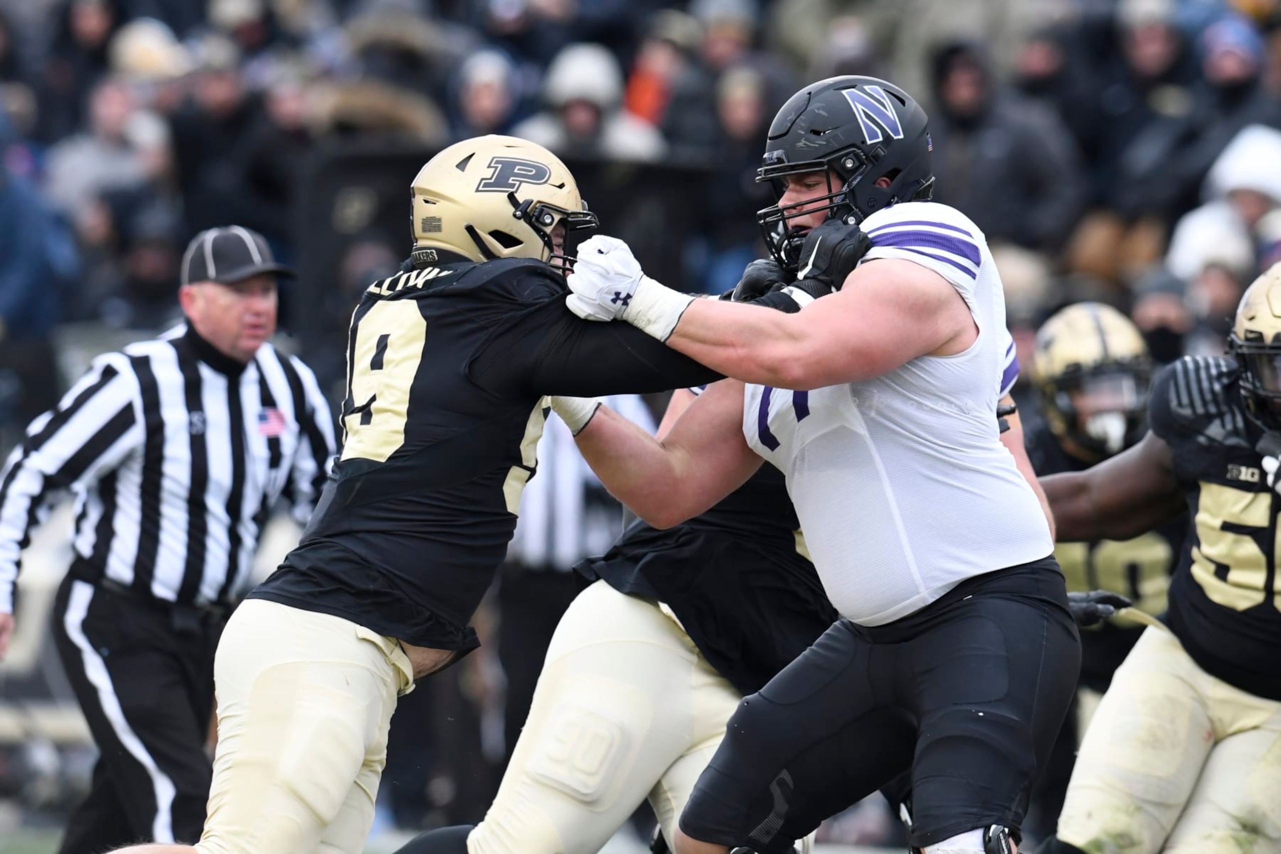 WEST LAFAYETTE, IN - NOVEMBER 19: Northwestern Wildcats offensive lineman Peter Skoronski (77) blocks Purdue Boilermakers defensive end Jack Sullivan (99) during the college football game between the Northwestern Wildcats and the Purdue Boilermakers on November 19, 2022, at Ross-Ade Stadium in West Lafayette, Indiana. (Photo by Michael Allio/Icon Sportswire via Getty Images)