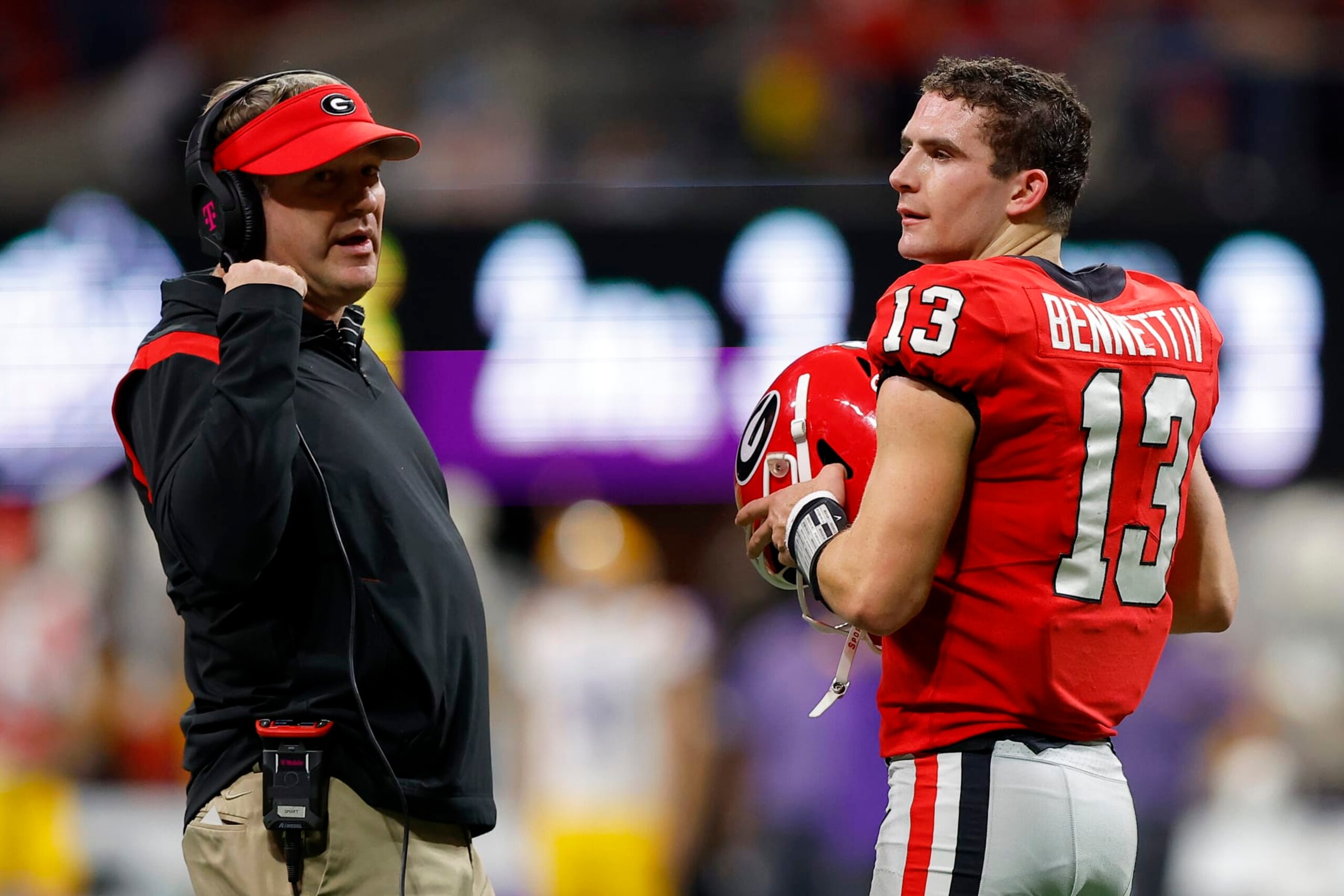 ATLANTA, GEORGIA - DECEMBER 03: Stetson Bennett #13 of the Georgia Bulldogs talks with Head coach Kirby Smart on the sideline against the LSU Tigers during the second quarter in the SEC Championship game at Mercedes-Benz Stadium on December 03, 2022 in Atlanta, Georgia. (Photo by Todd Kirkland/Getty Images)