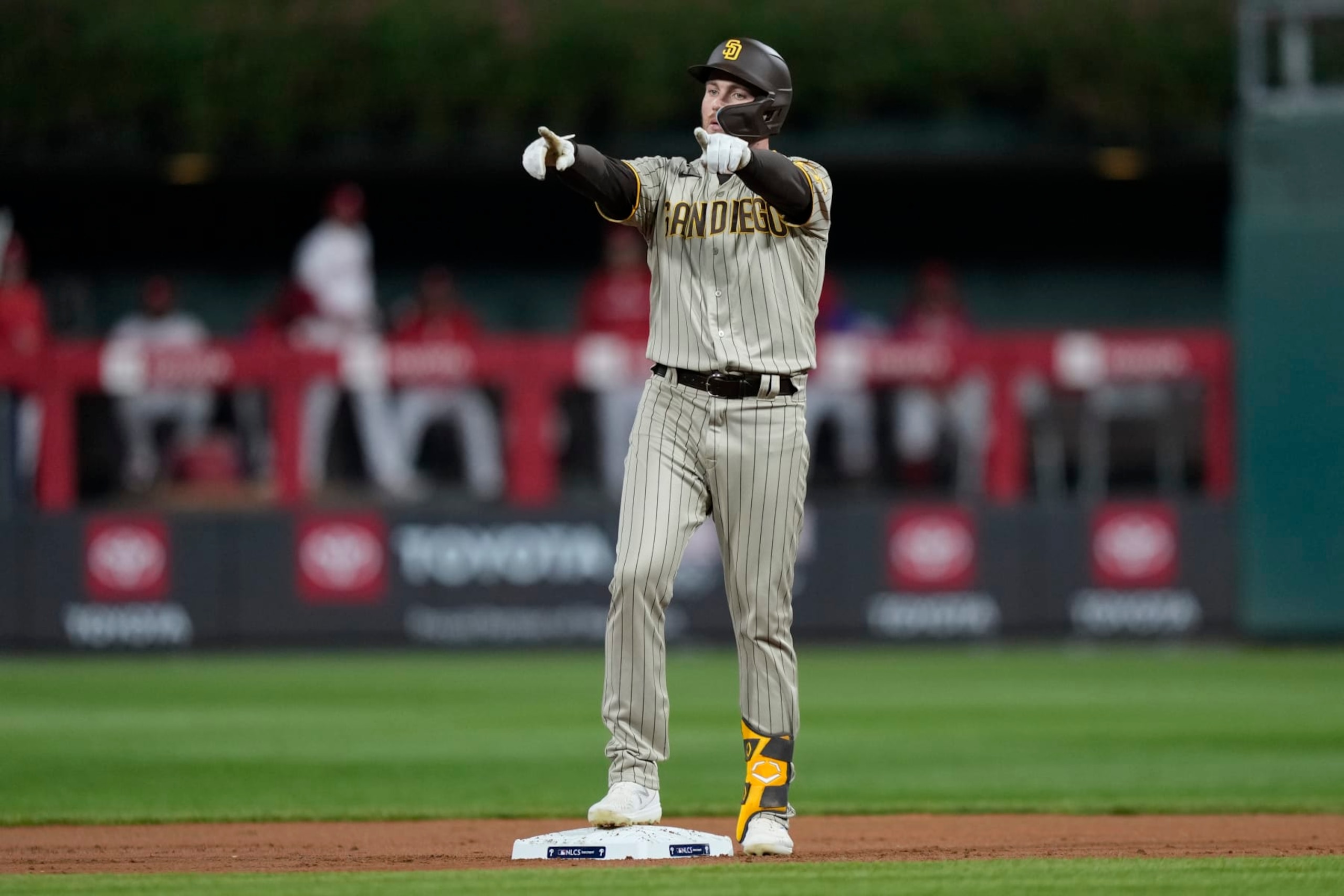 San Diego Padres' Brandon Drury celebrates after a two-run double during the first inning in Game 4 of the baseball NL Championship Series between the San Diego Padres and the Philadelphia Phillies on Saturday, Oct. 22, 2022, in Philadelphia. (AP Photo/Matt Slocum)